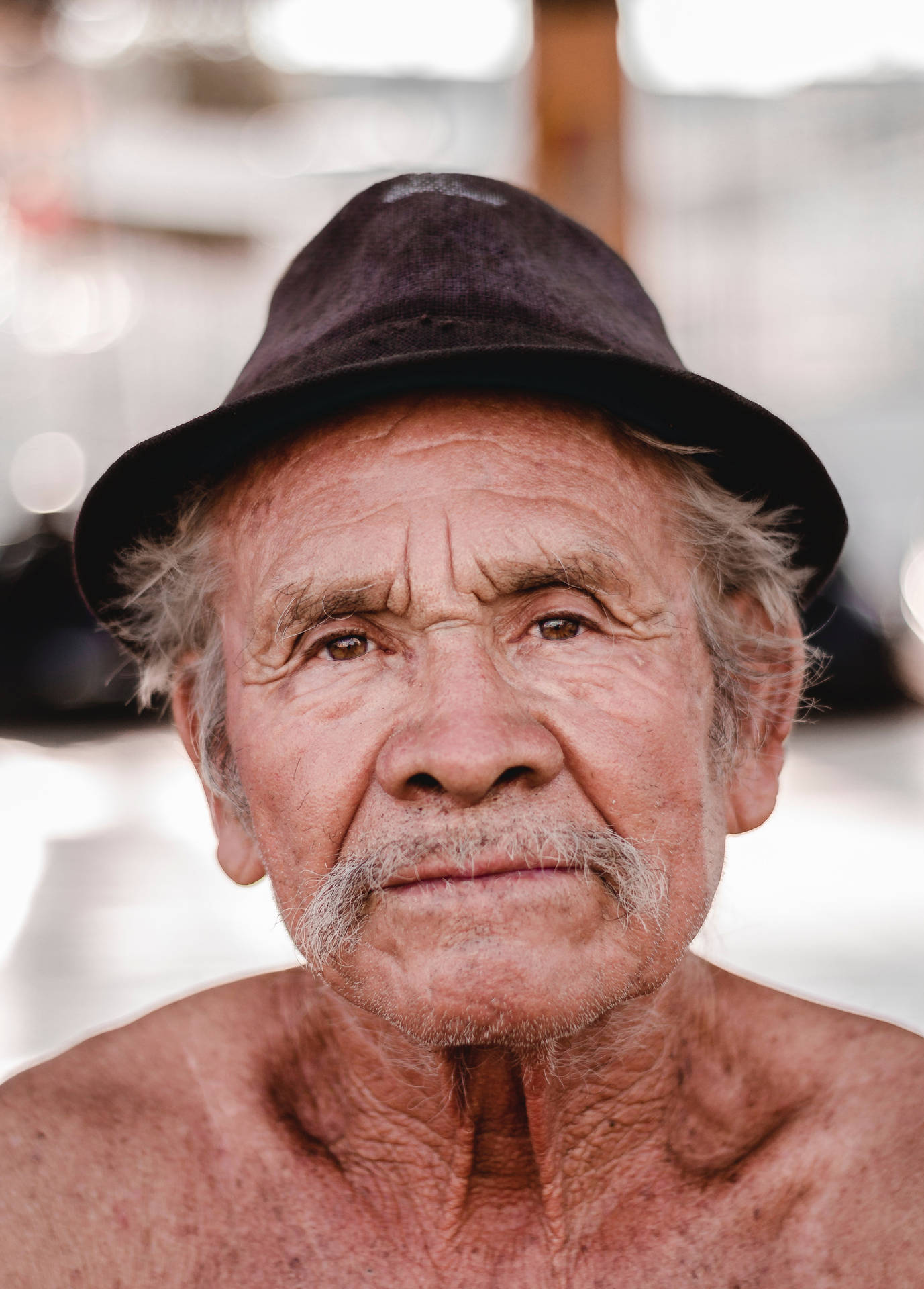 Portrait Of An Elderly Man Adorned In Black Fedora Hat Background