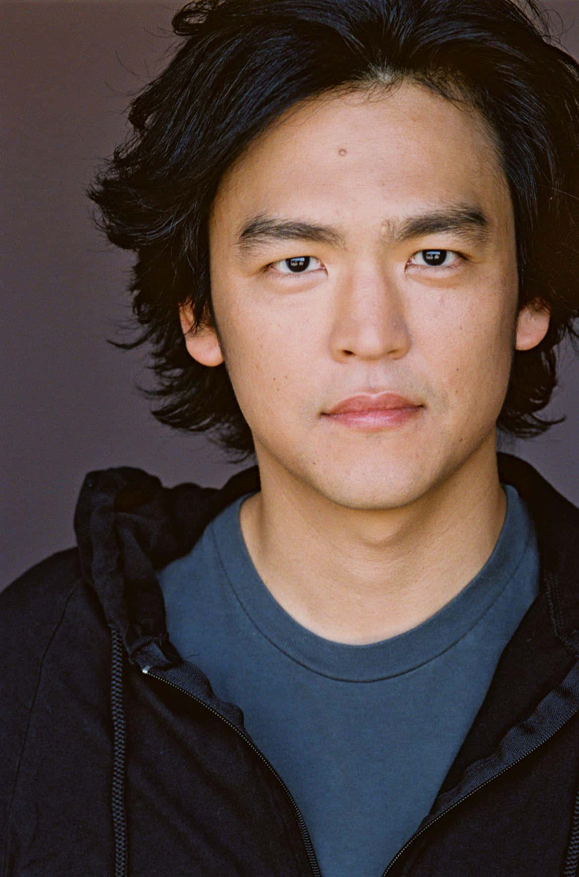 Portrait Of John Cho Looking Stylish And Confident Background