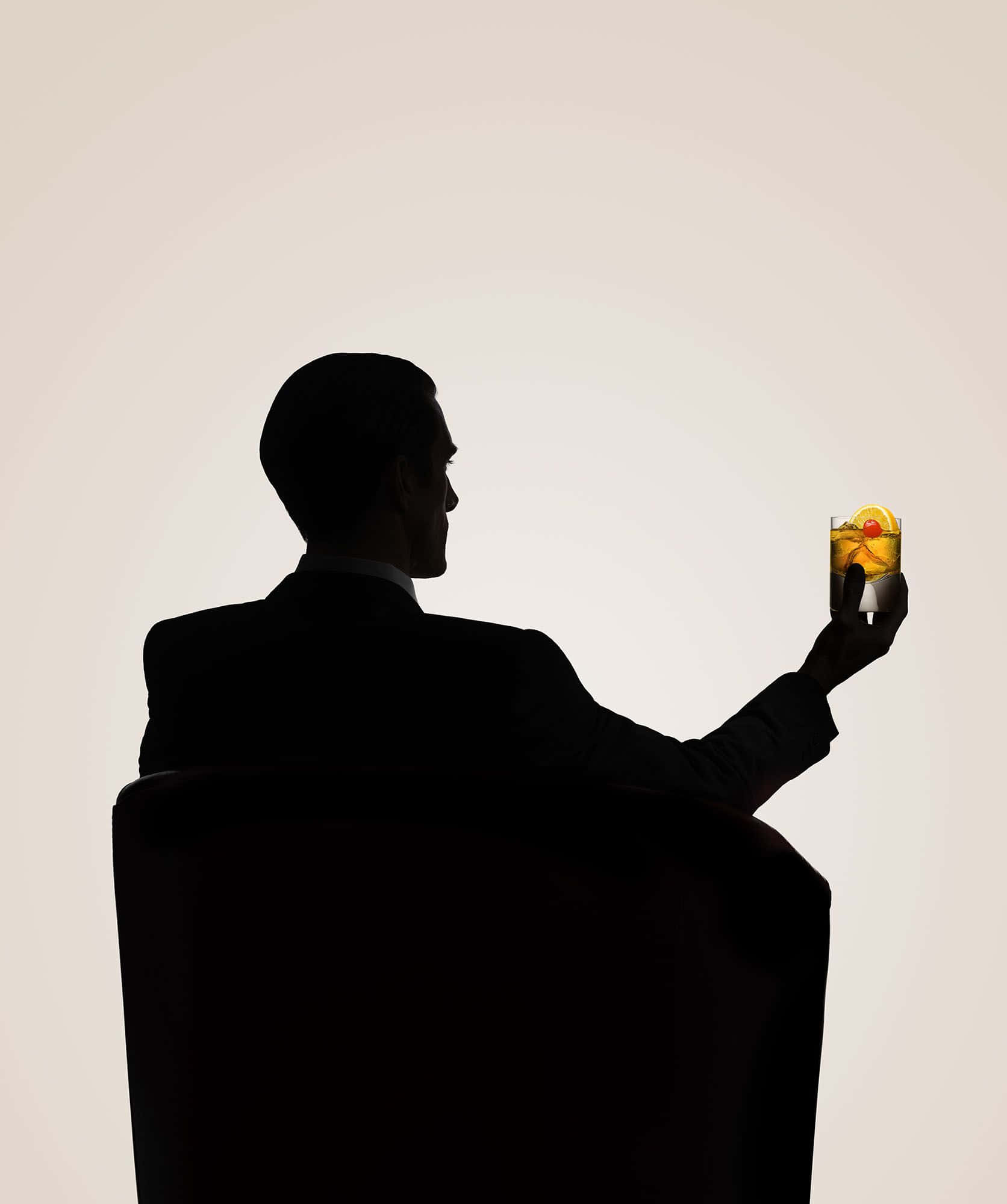 Portraying Elegance: Jon Hamm In Classic Black Suit Background