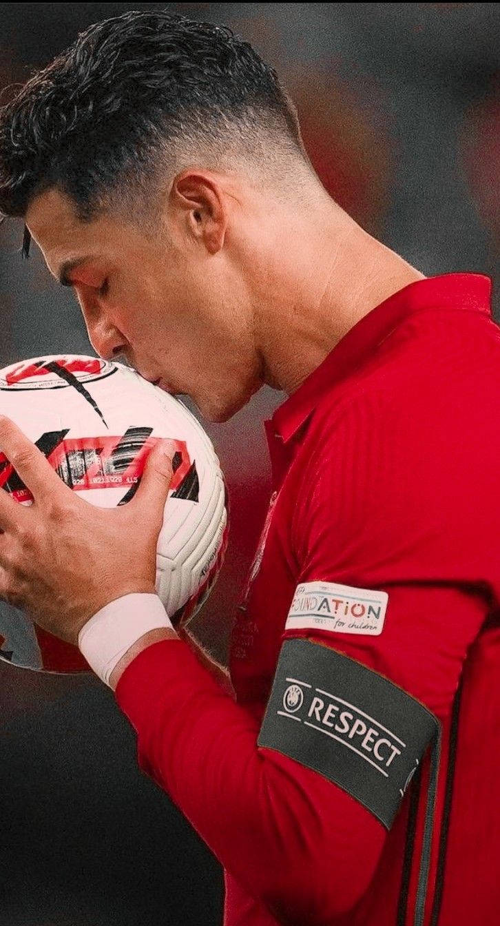 Portugal National Football Team Cristiano Kissing A Ball Background