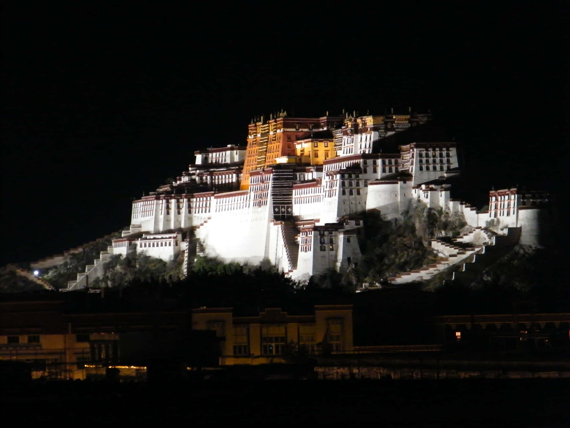 Potala Palace Above The Mountain In Lhasa Background