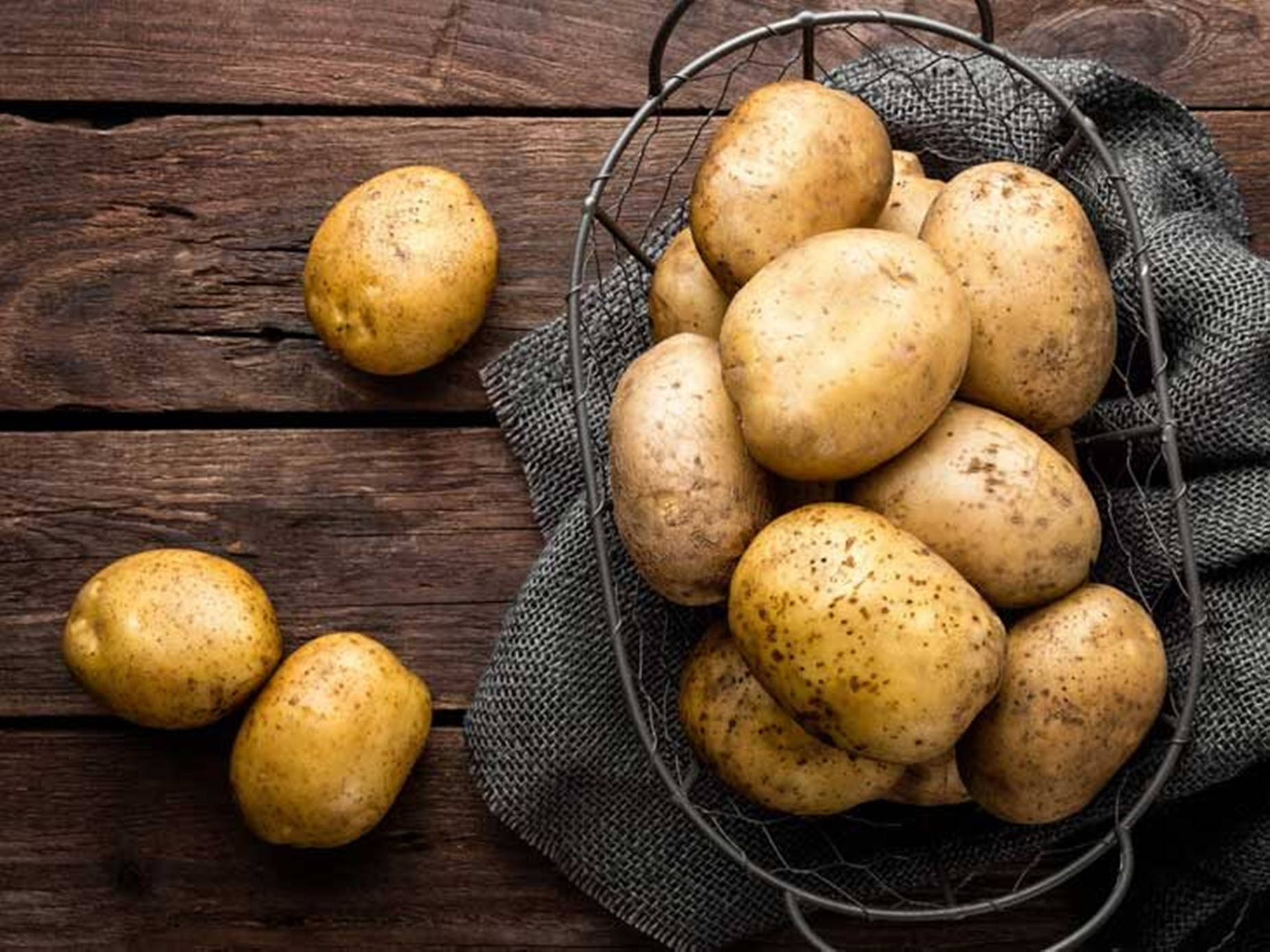 Potatoes On A Rustic Wire Basket Background