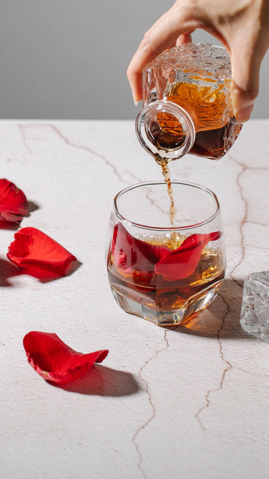 Pouring Glass Of Alcohol On Marble Background
