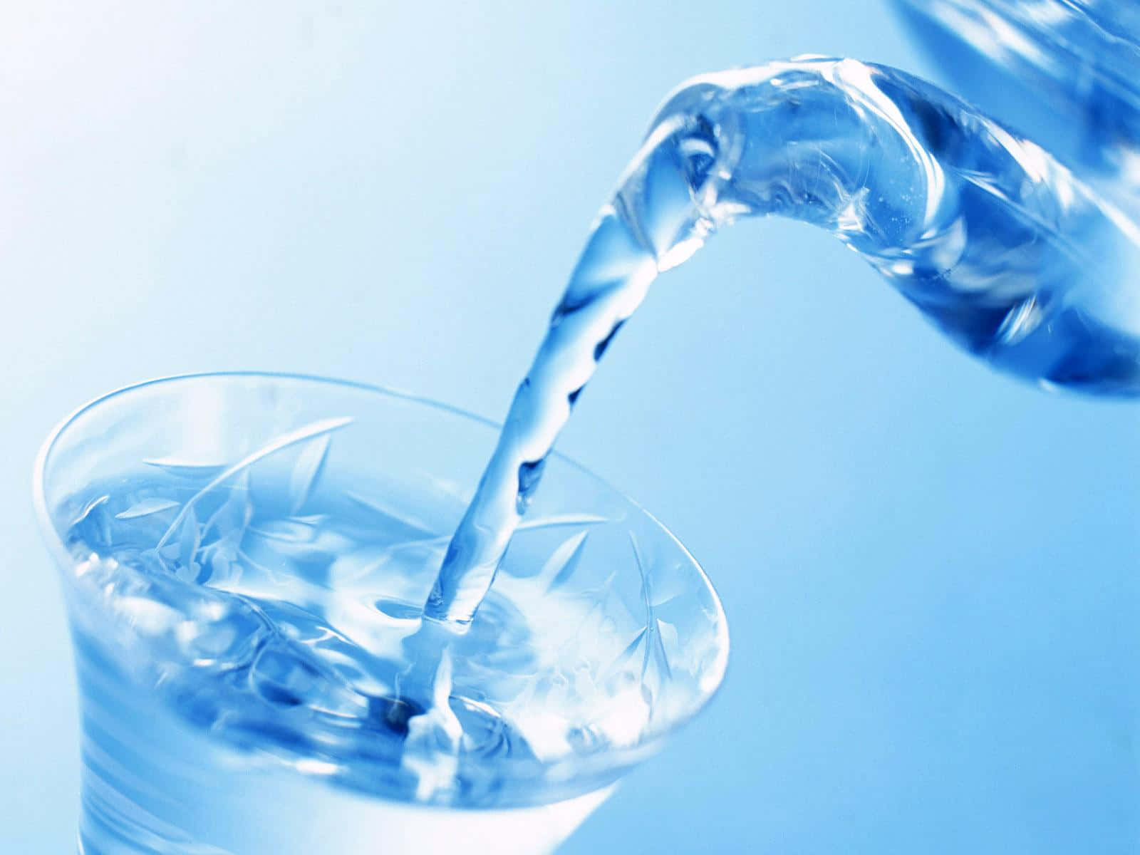 Pouring Pure Water Into Glass Background