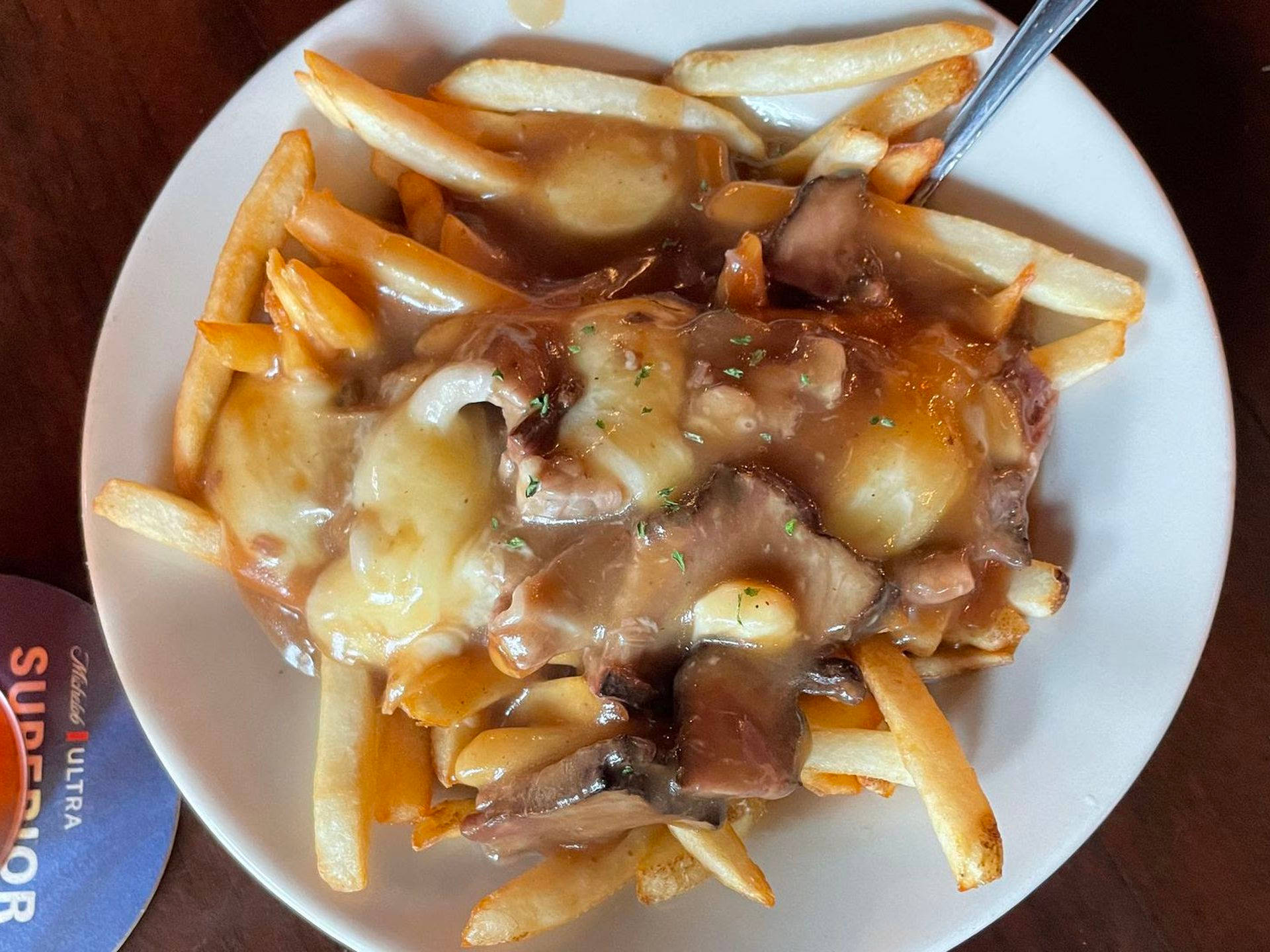 Poutine Drenched In Gravy With Meat Background