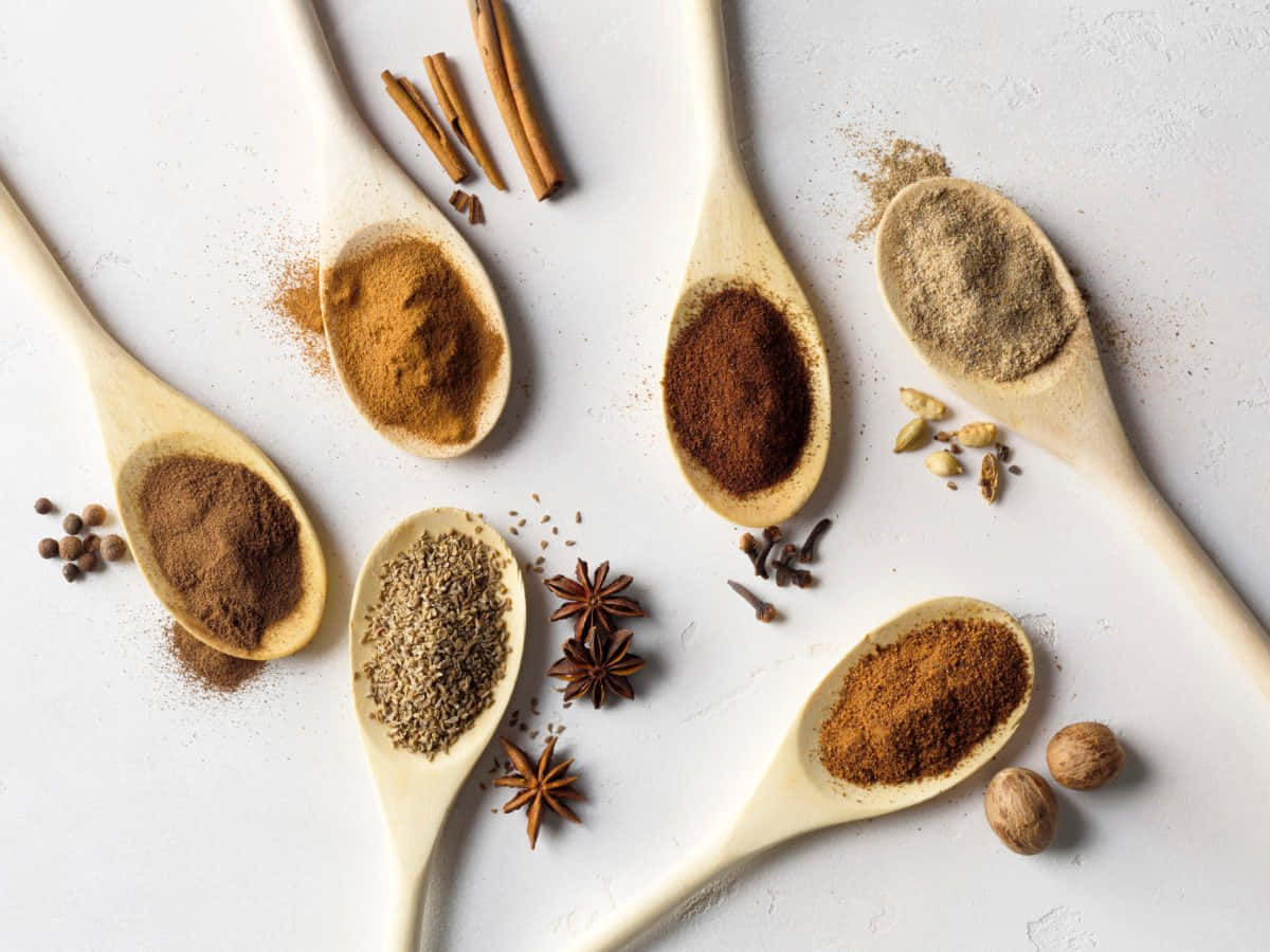 Powdered Spices On Porcelain Spoons Background