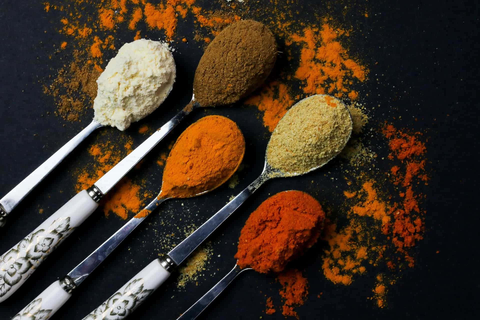 Powdered Spices On Silver Spoons