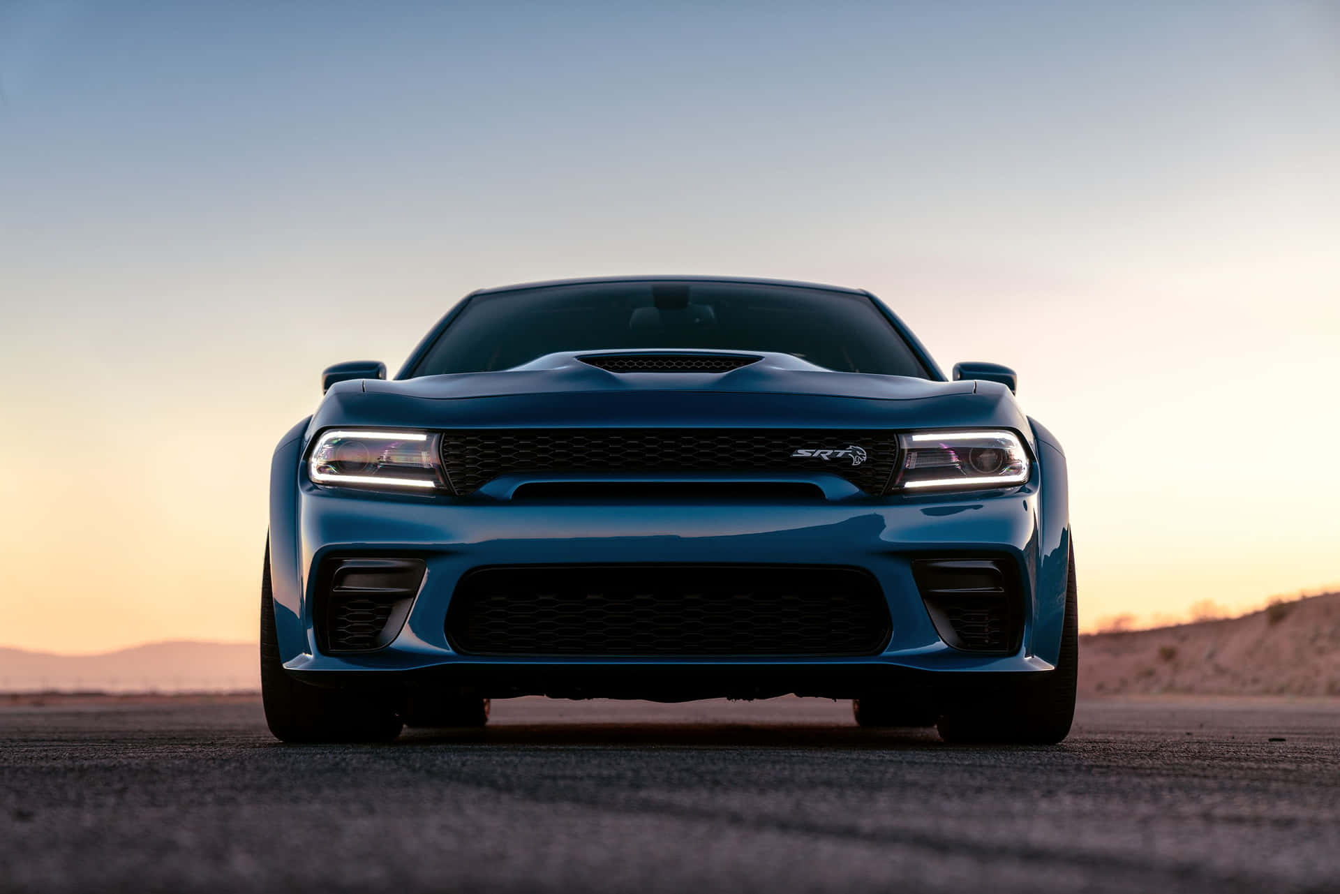 Powerful Dodge Charger Cruising Down The Highway Background