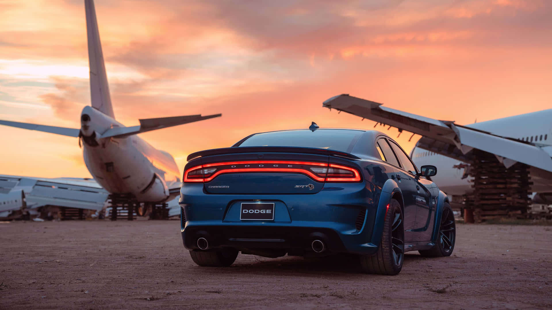 Powerful Dodge Charger Roaring On The Road Background