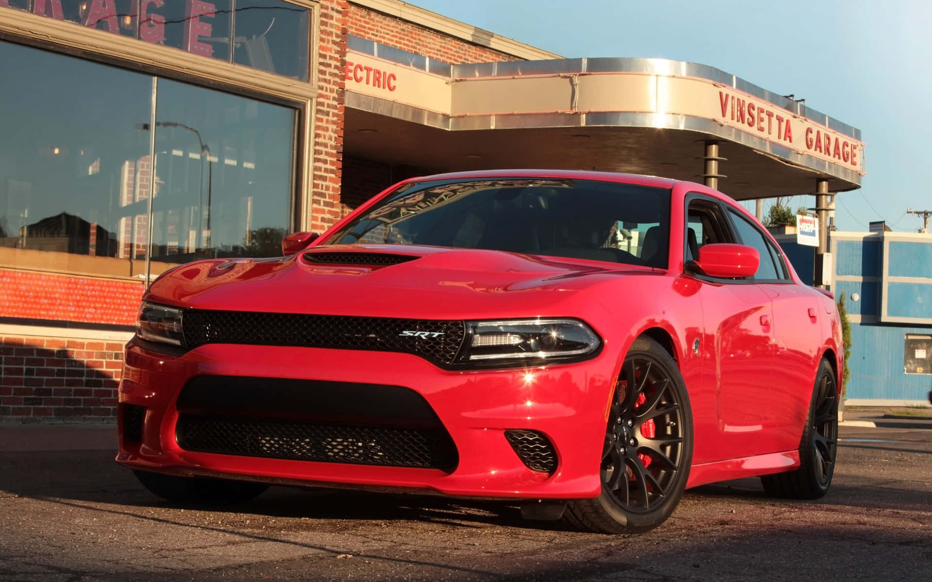 Powerful Dodge Charger Speeding Down The Road Background