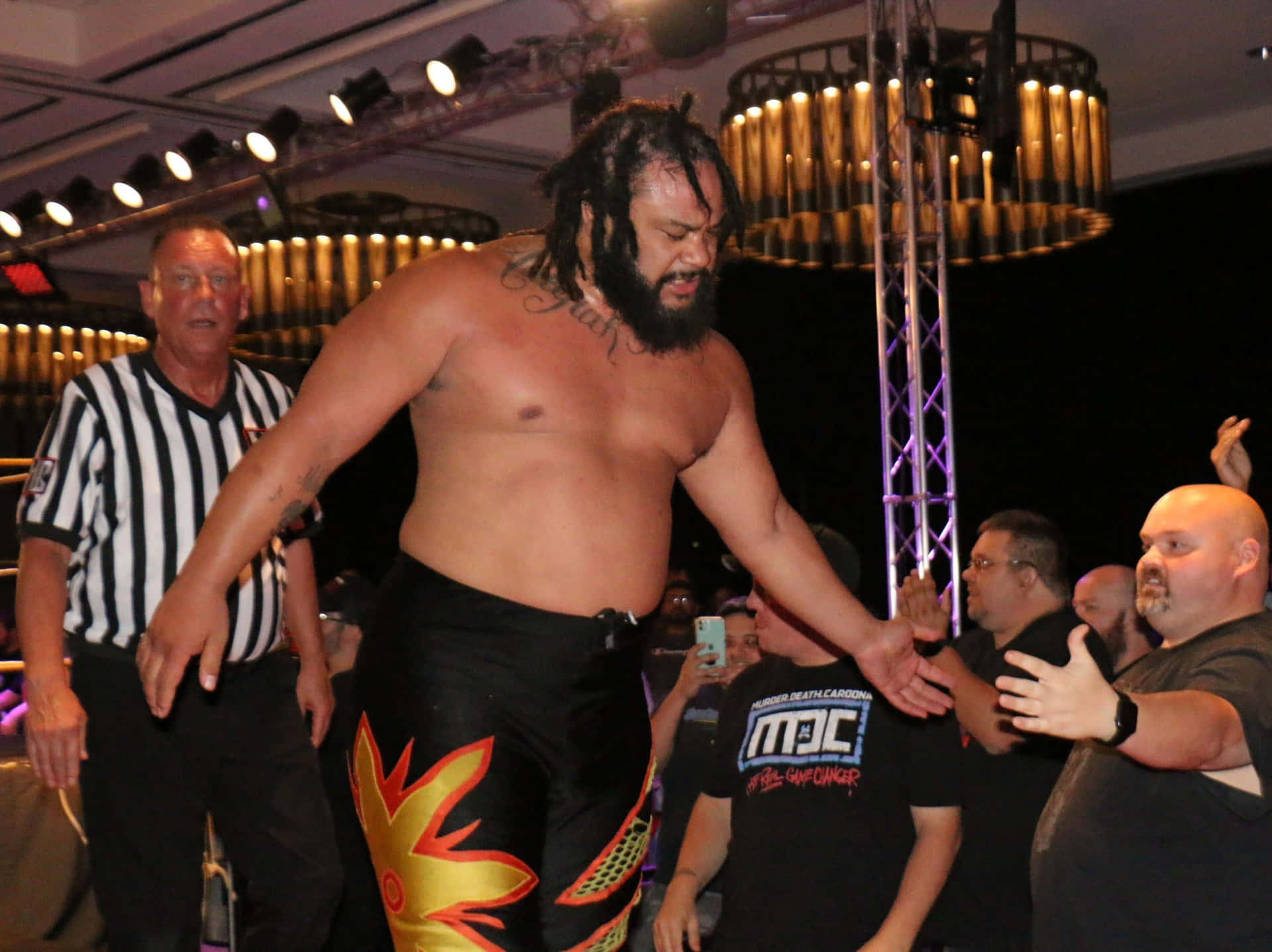Powerhouse Wrestler Jacob Fatu Striking A Pose Background