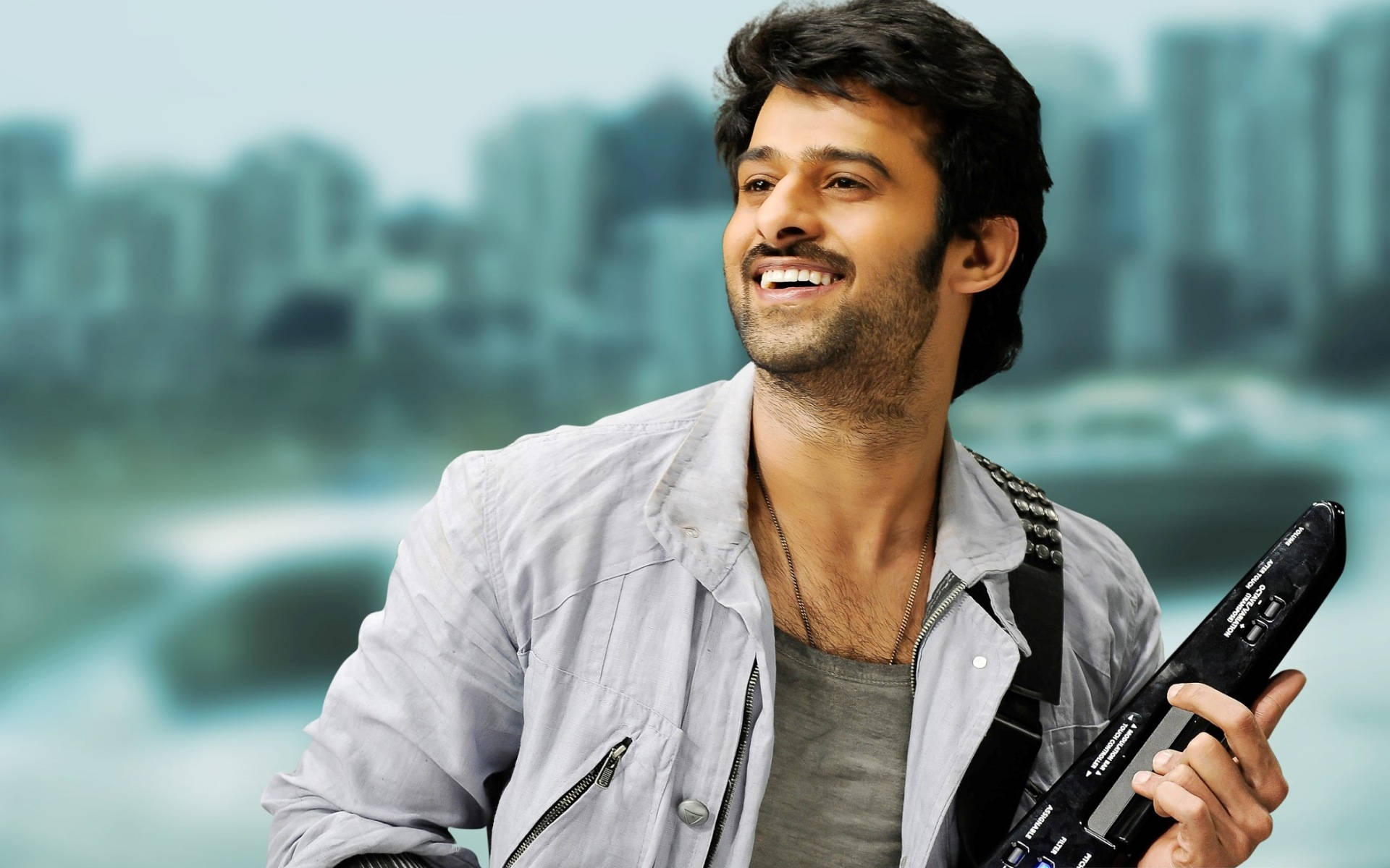 Prabhas Hd Holding An Instrument Background