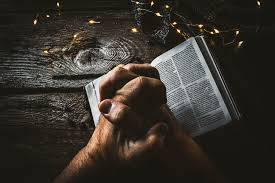 Prayer Book Wood Hands Lights Background