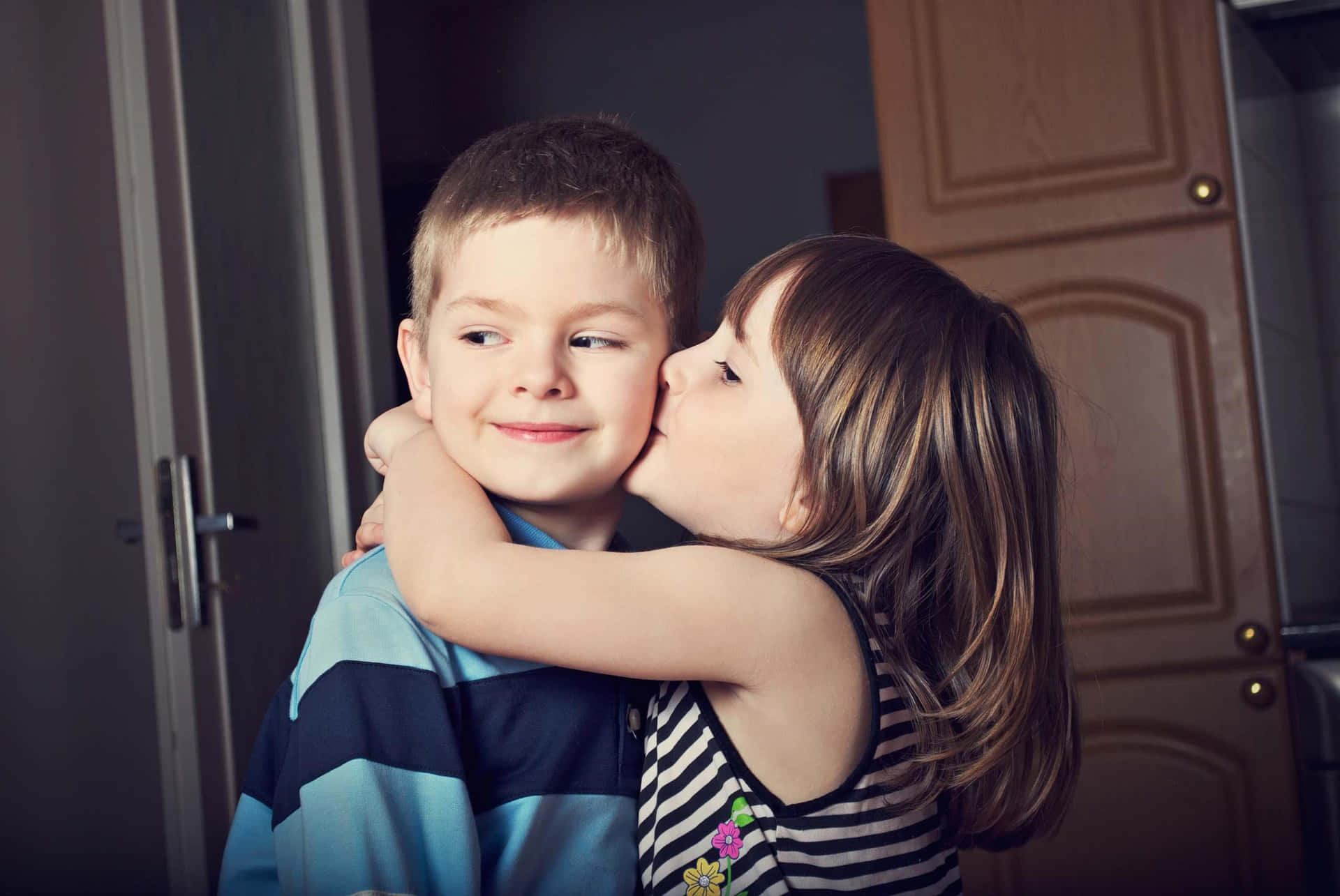 Precious Moments - Sweet Baby Couple Share A Cheek Kiss Background