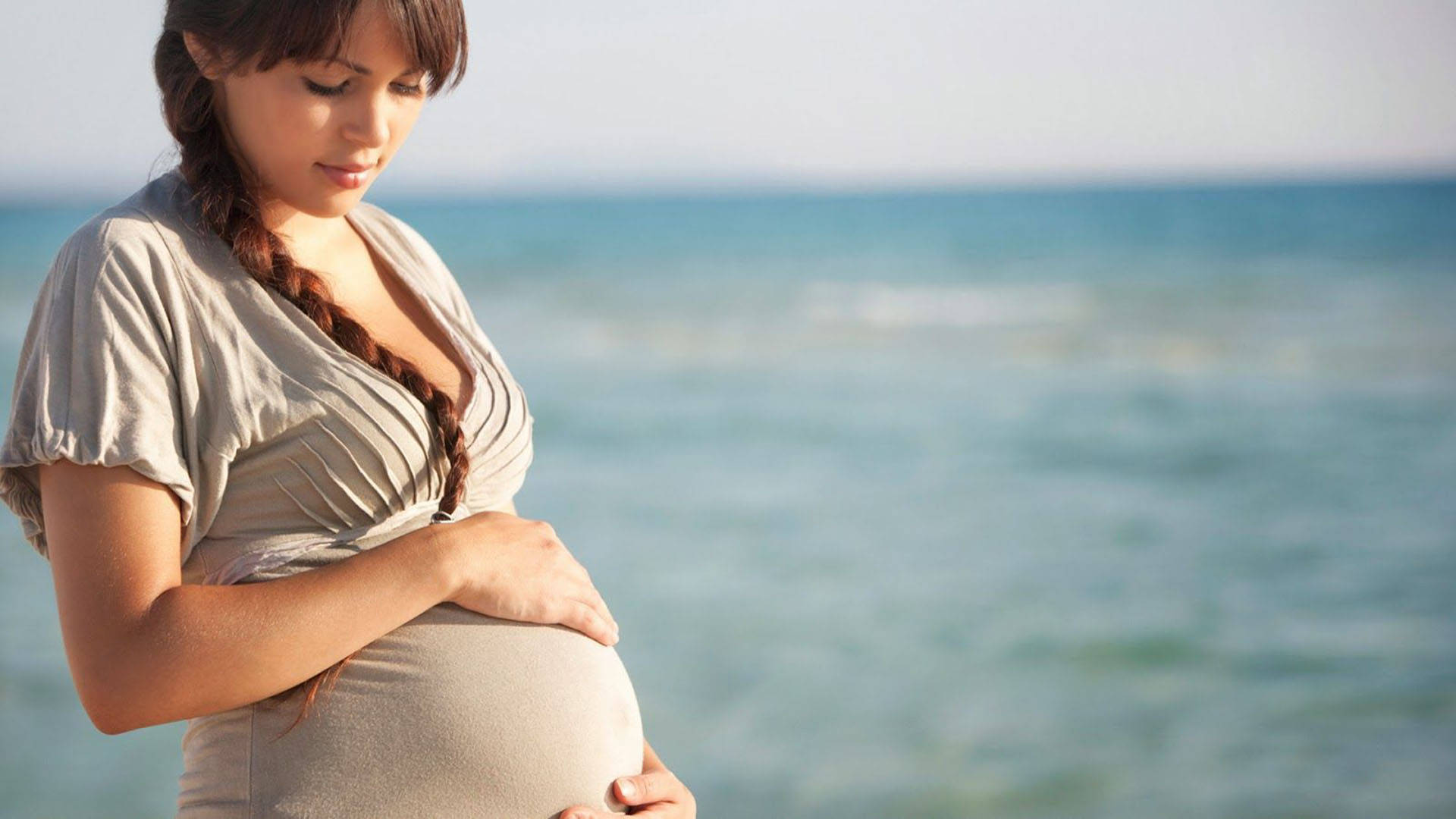 Pregnant At Beach Shore Background