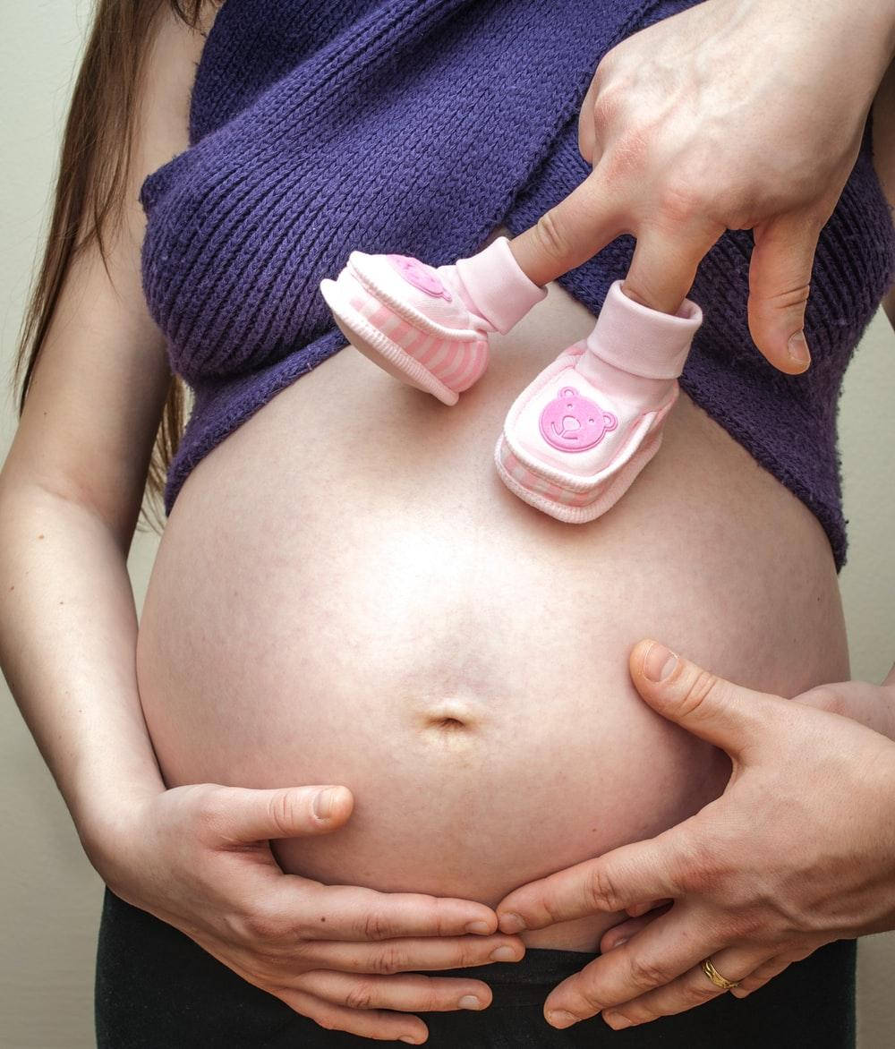 Pregnant Belly Baby Shoes Fingers Background