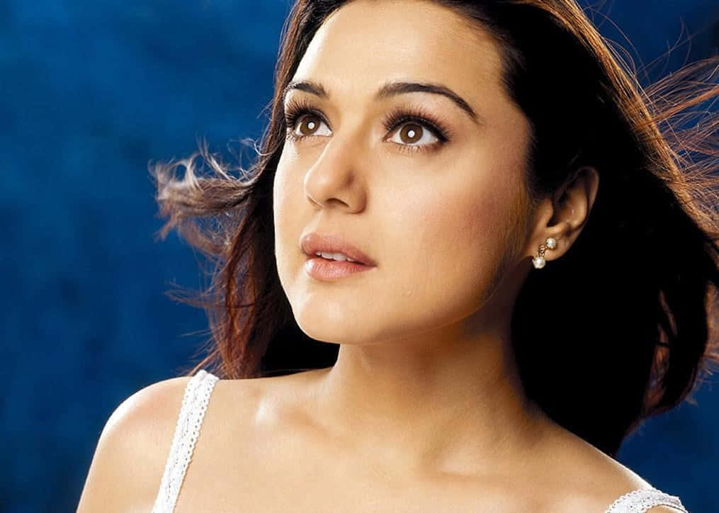 Preity Zinta Flowing Hair Blue Background