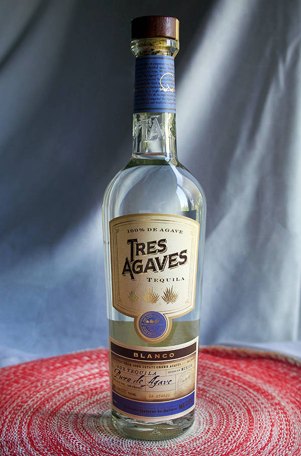 Premium Blanco Tres Agaves Tequila Against A White Cloth Backdrop Background