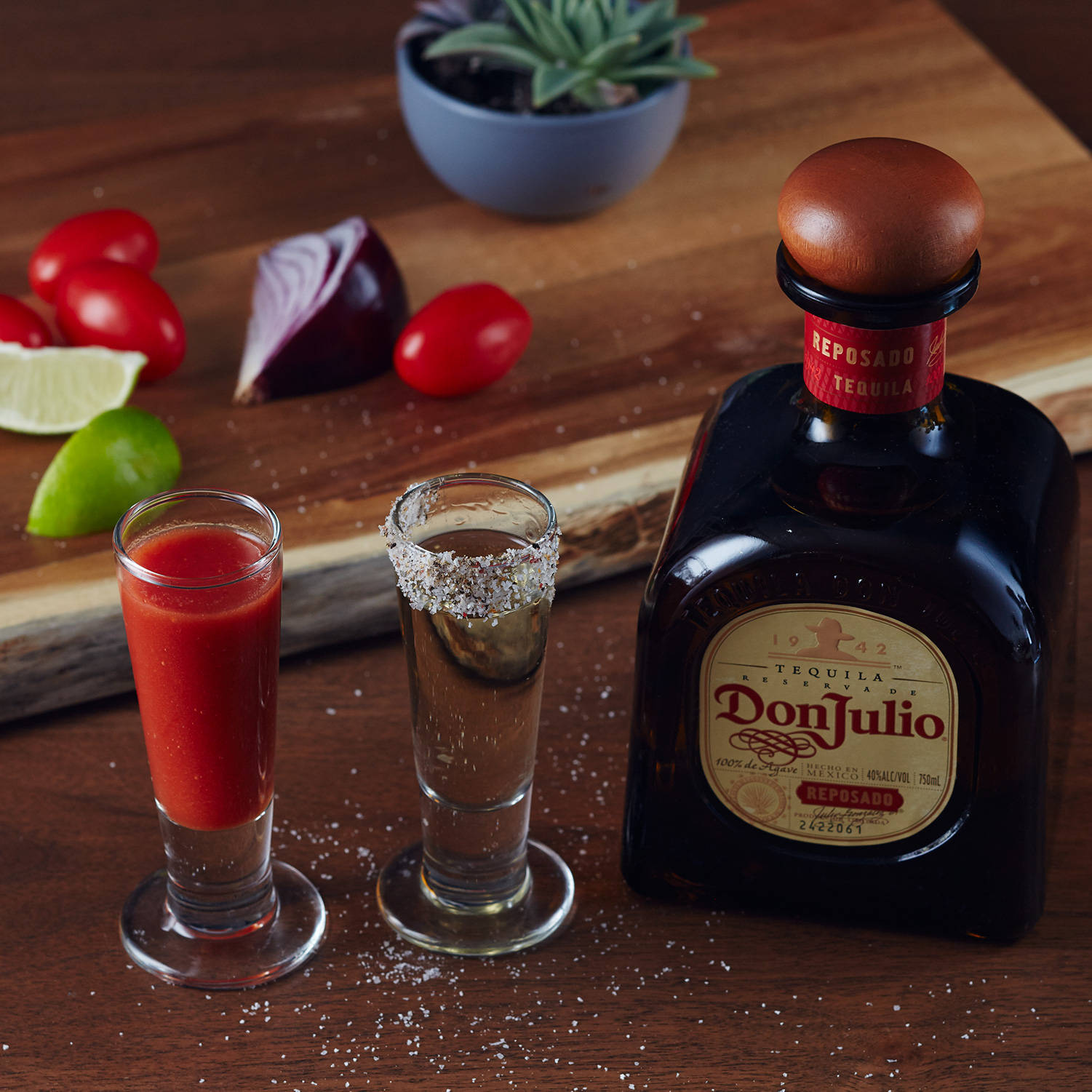 Premium Don Julio Tequila Beside A Delicious Vegetable Mixture Background