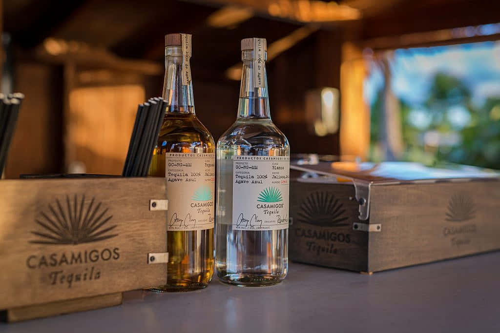 Premium Experience With Casamigos Tequila Reposado And Blanco Liquor Bottles Background