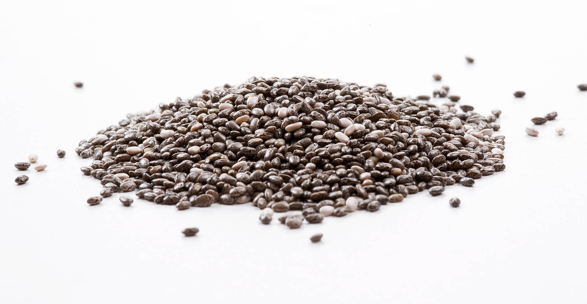 Premium Quality Chia Seeds Spilled Over A Pristine White Surface Background