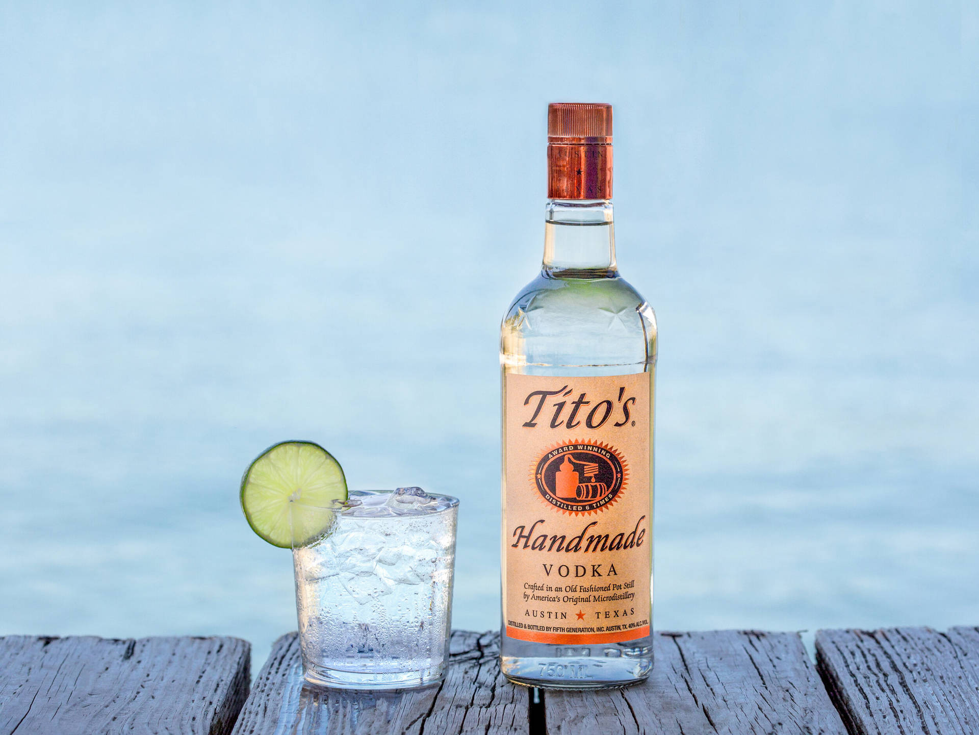 Premium Tito's Vodka Served With A Fresh Lime Slice Background