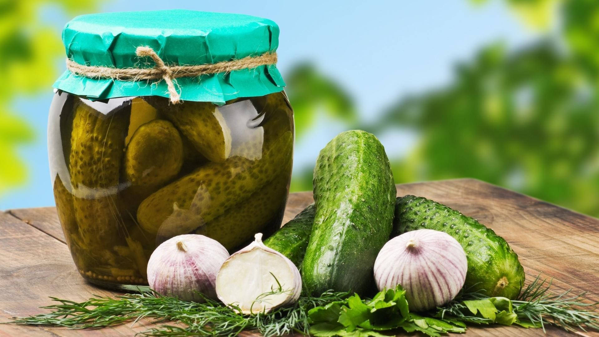 Preserved Pickles In A Round Glass Jar Background