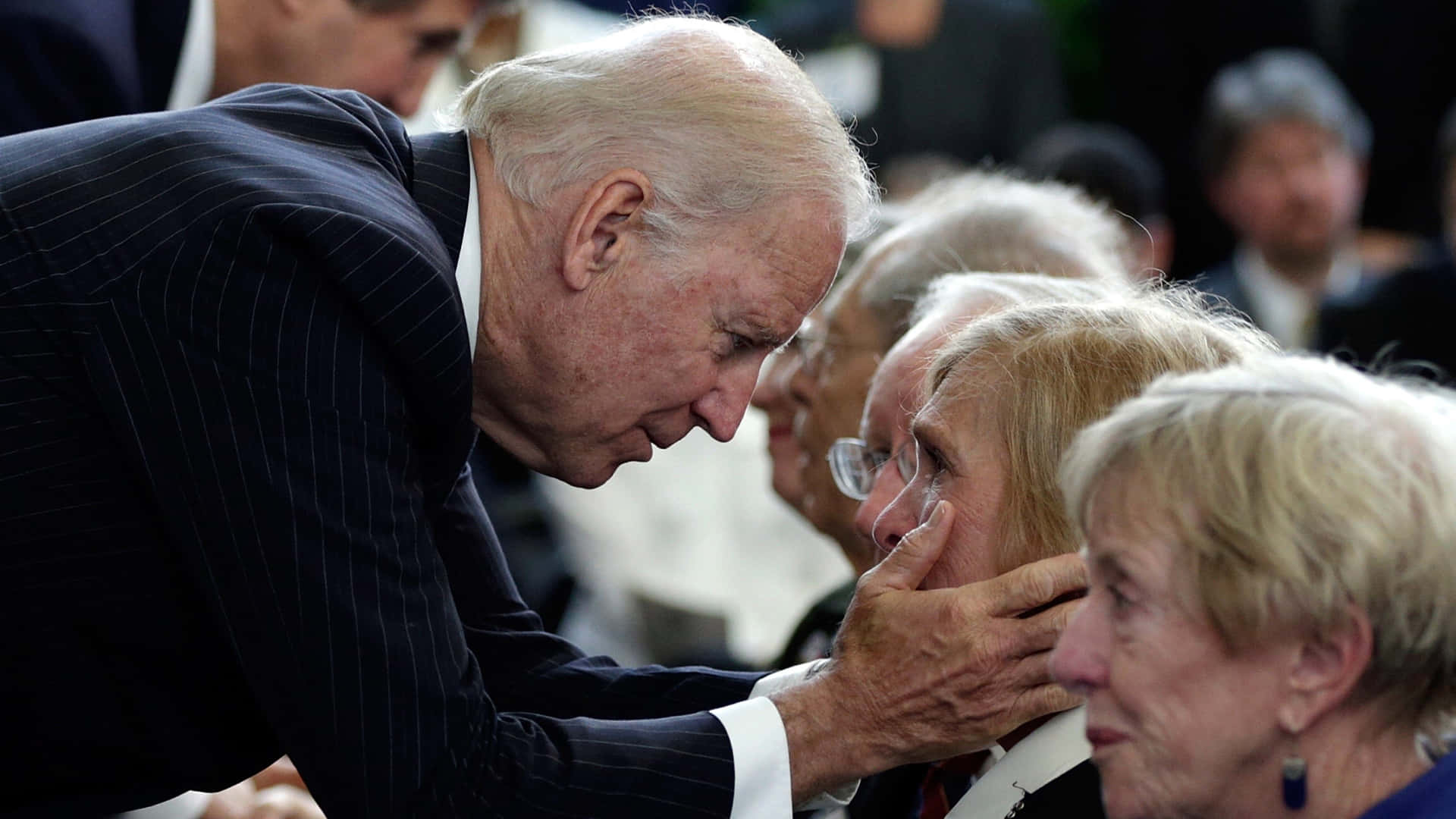 President Biden Comforting An Old Lady