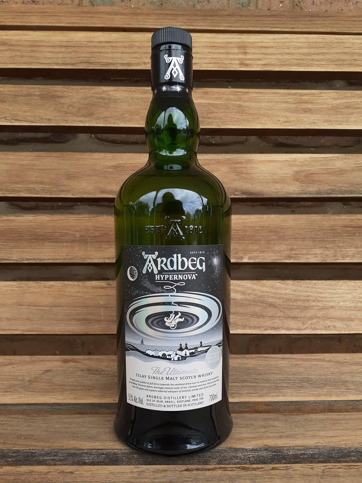 Prestigious Ardbeg Hypernova Whisky On Classic Wooden Bench Background