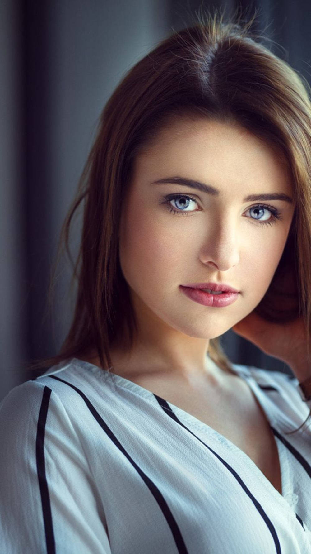 Pretty Woman Donning A Striped Top Background