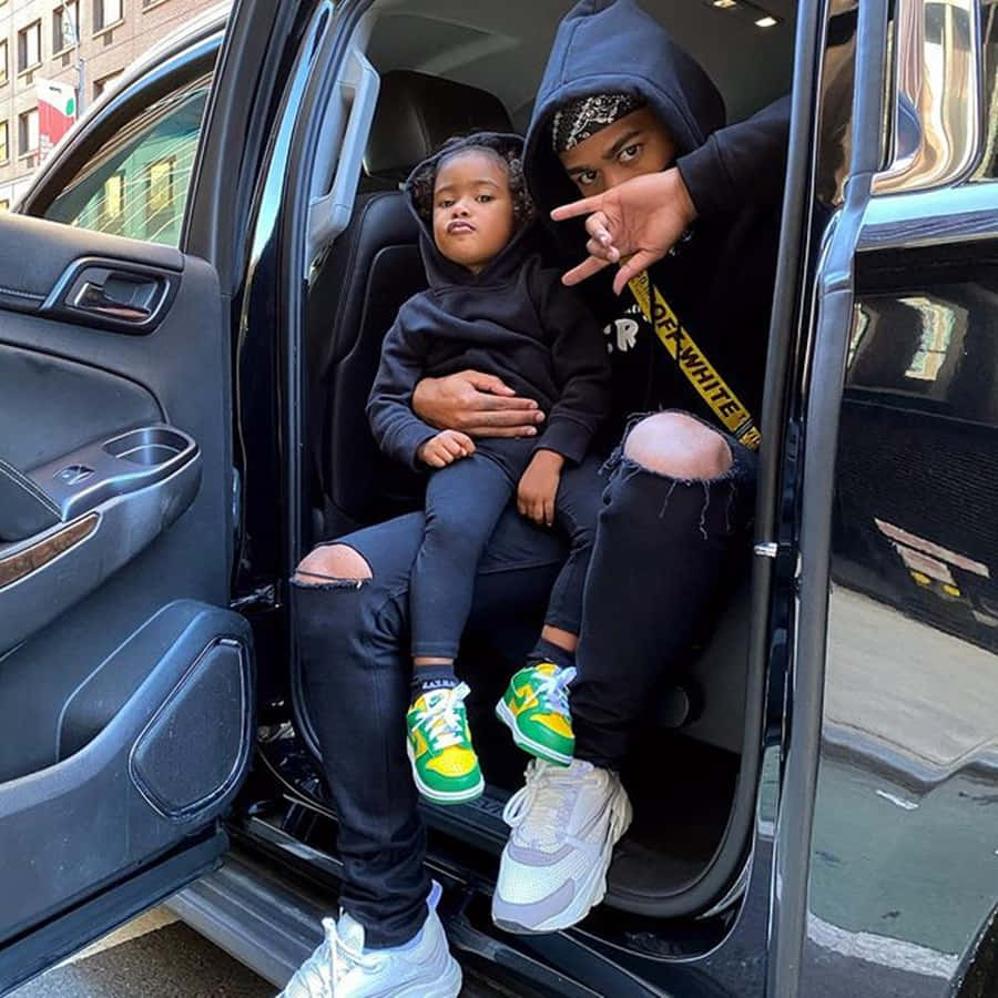 Prettyboyfredo With Daughter In Car Background
