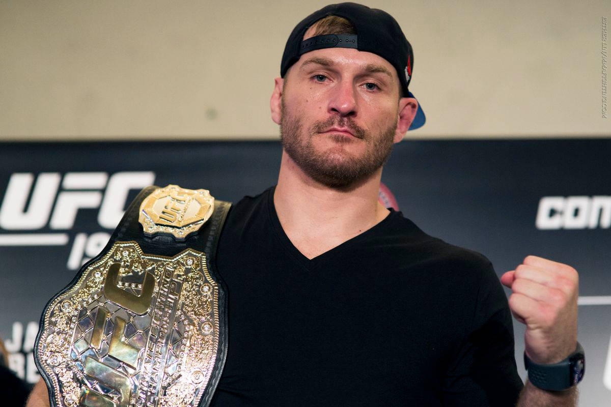 Pride Of The Octagon, Stipe Miocic Posing With Ufc Title Belt Background