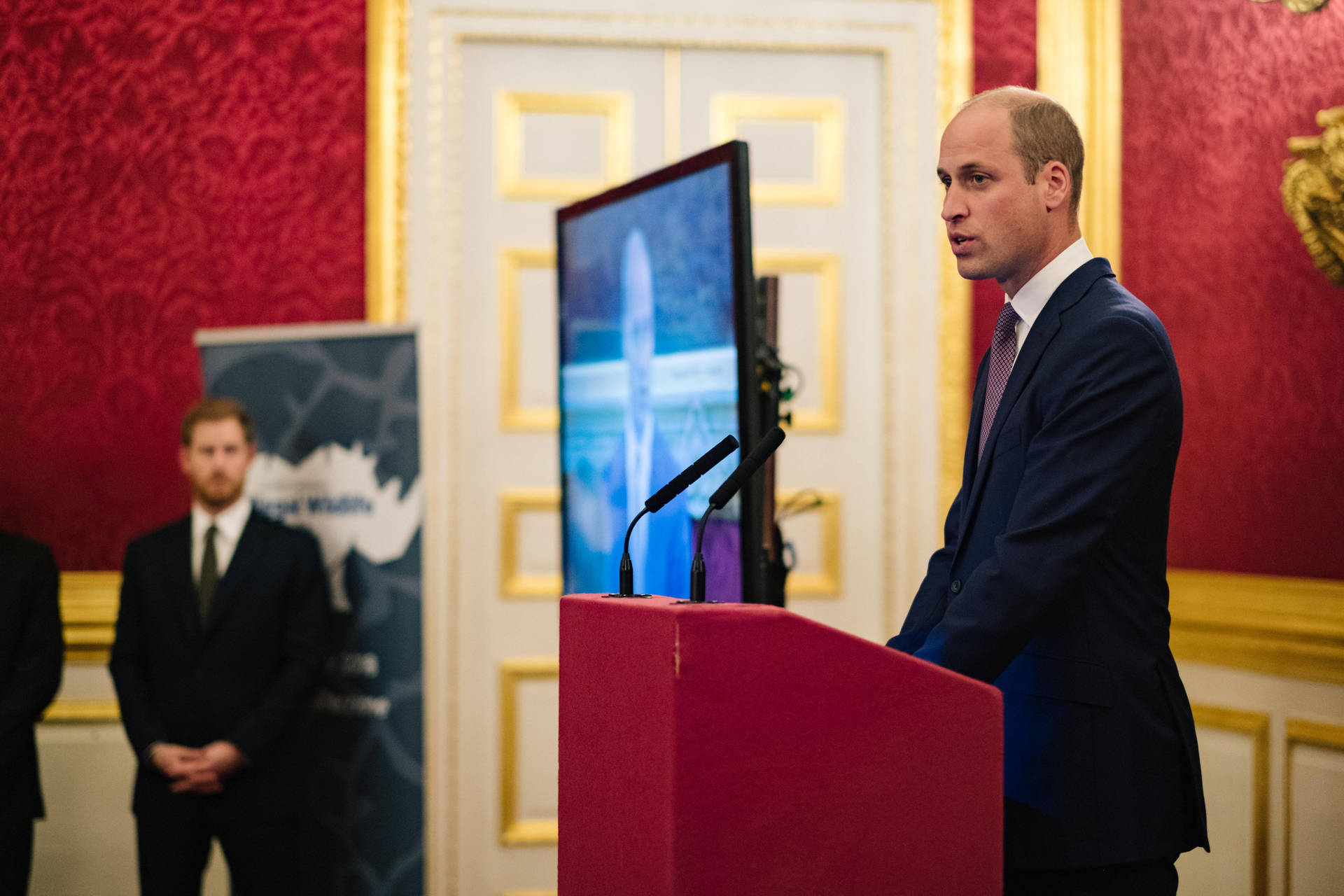 Prince William Speaking At The Podium Background