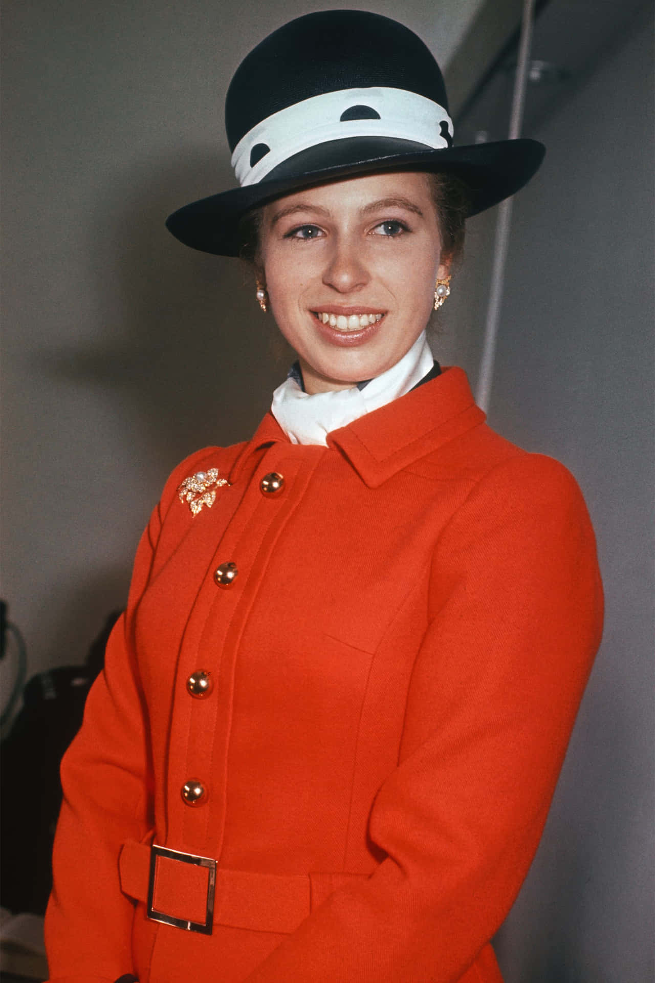 Princess Anne Sporting A Red Belted Jacket Background