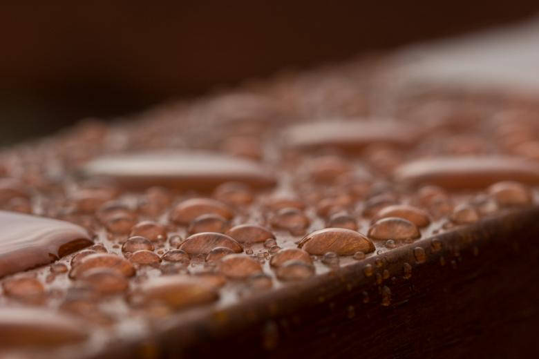 Pristine Water Droplets On Polished Wood Background