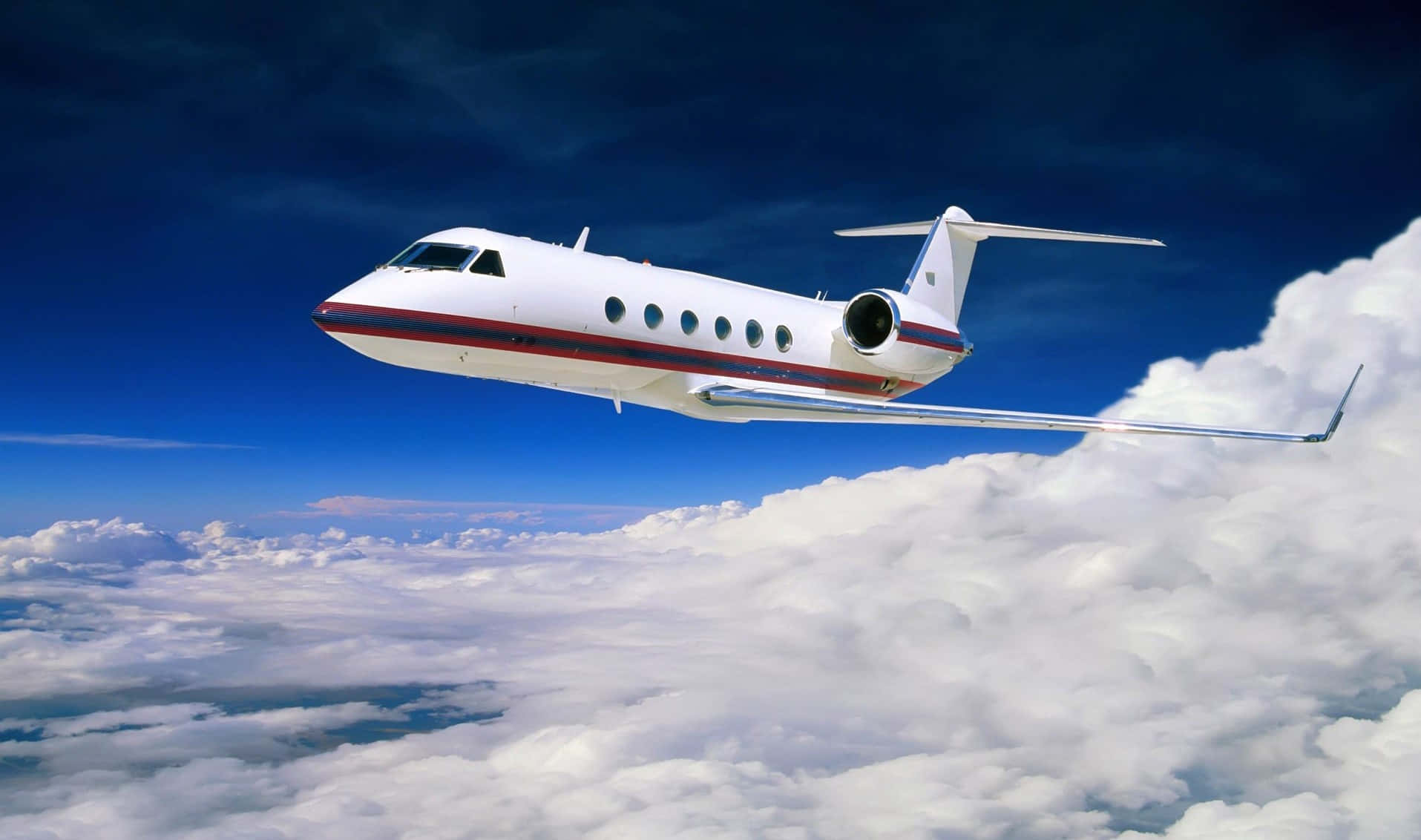 Private Jet Over Clouds Background