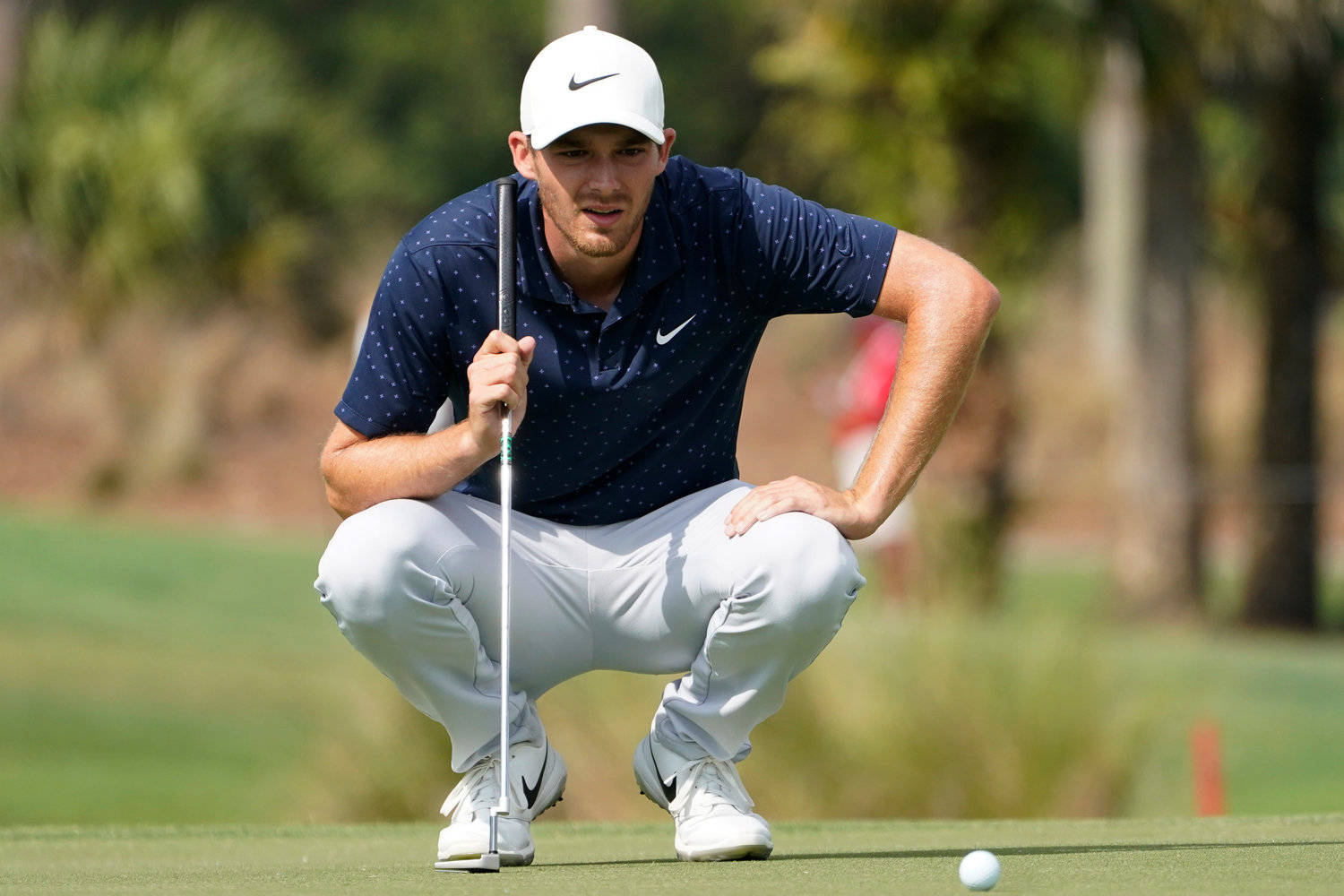 Pro Golfer Aaron Wise Strategizing On The Golf Field