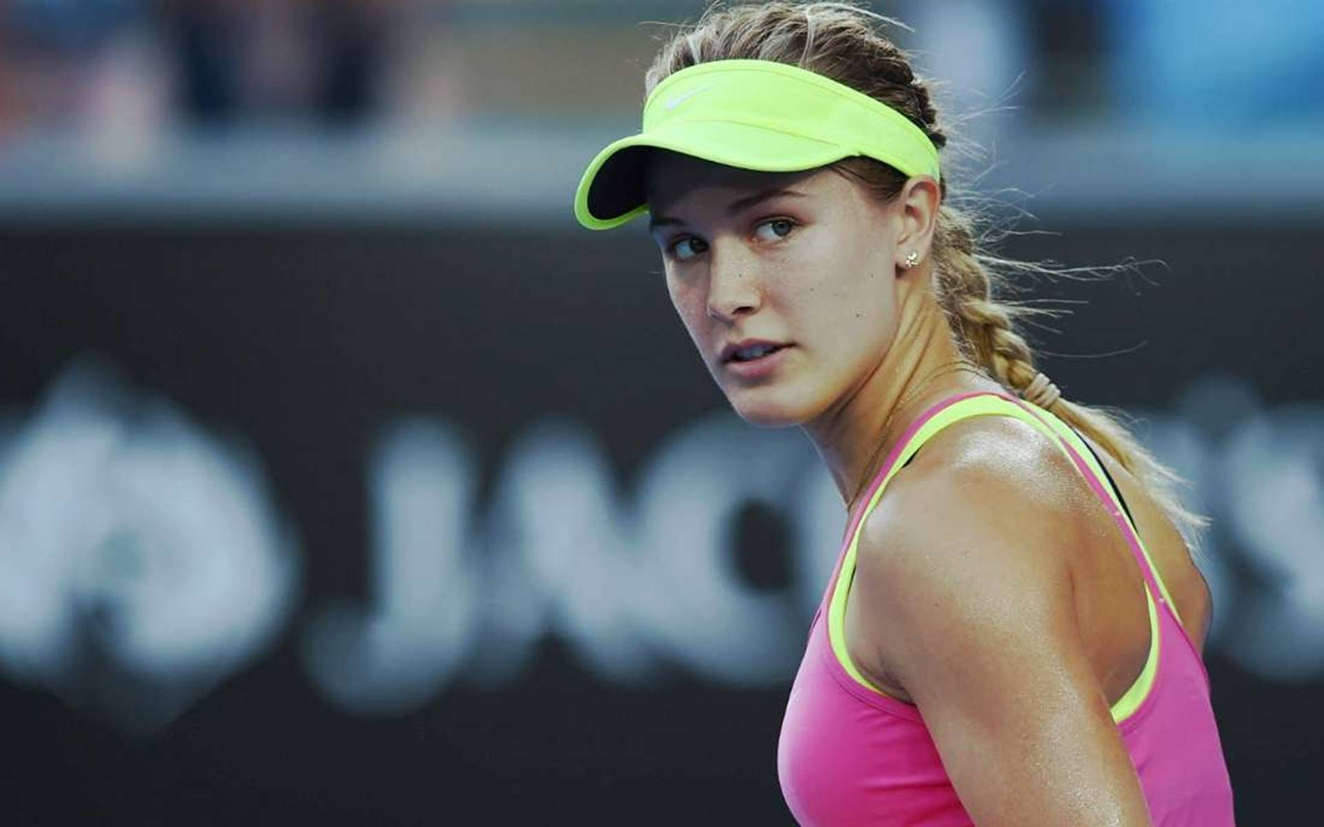 Pro Tennis Player Eugenie Bouchard Donning A Yellow Visor Background