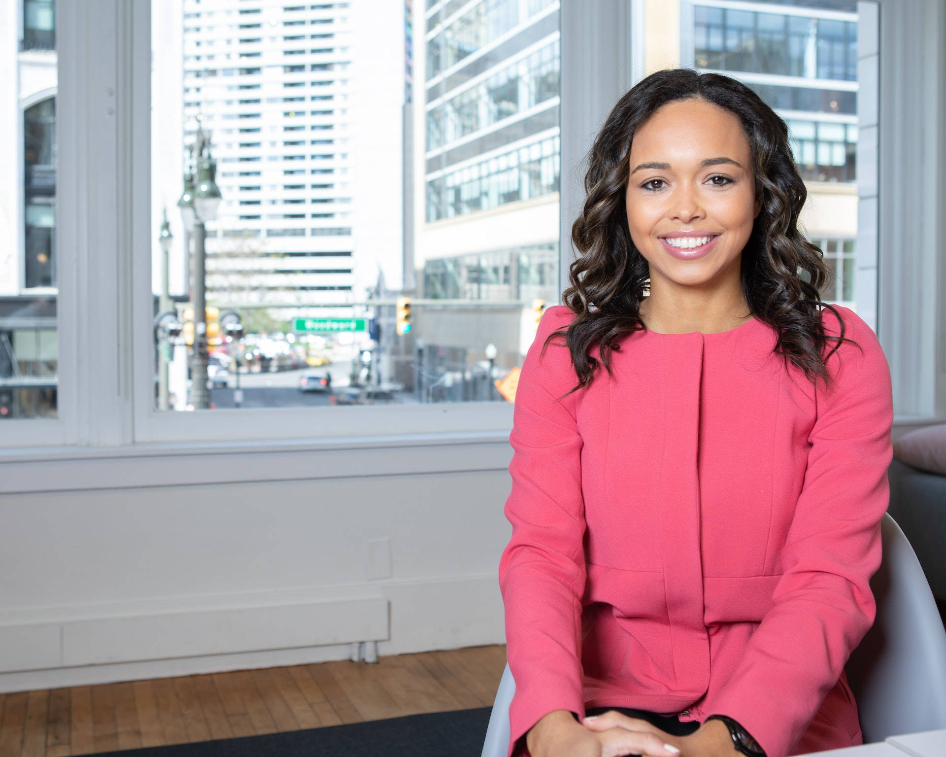 Professional Black Woman In Pink Top Background