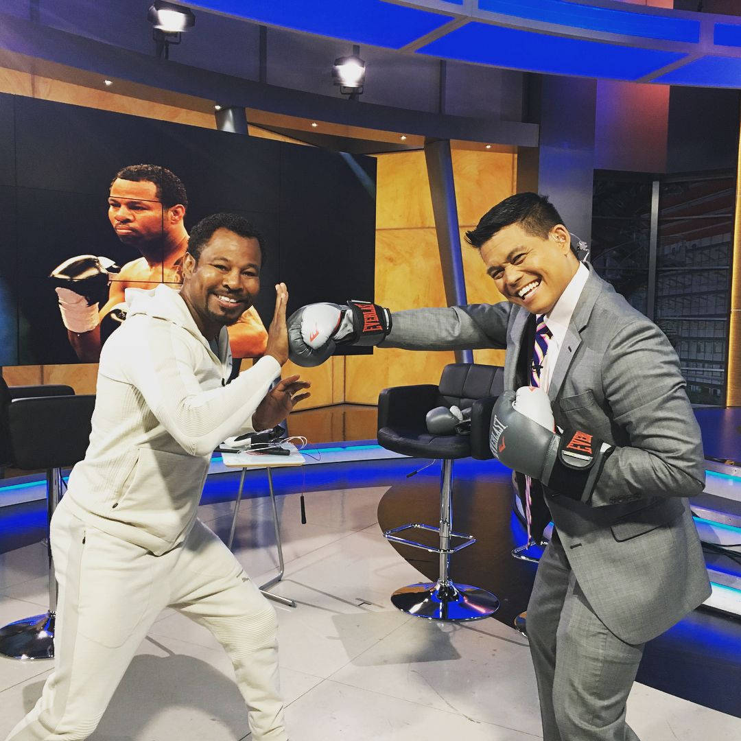 Professional Boxer Shane Mosley Playfully Defending In The Ring Background