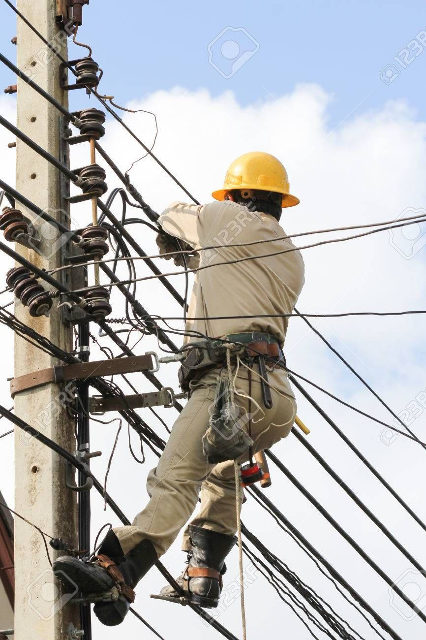 Professional Electrician Fixing An Electrical Post