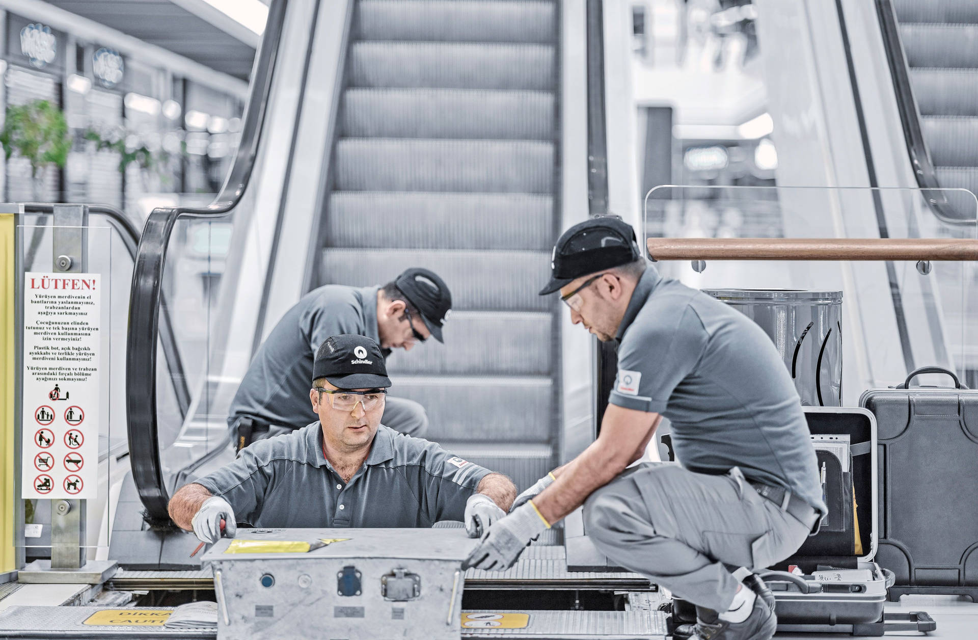 Professional Escalator Technician At Work Background