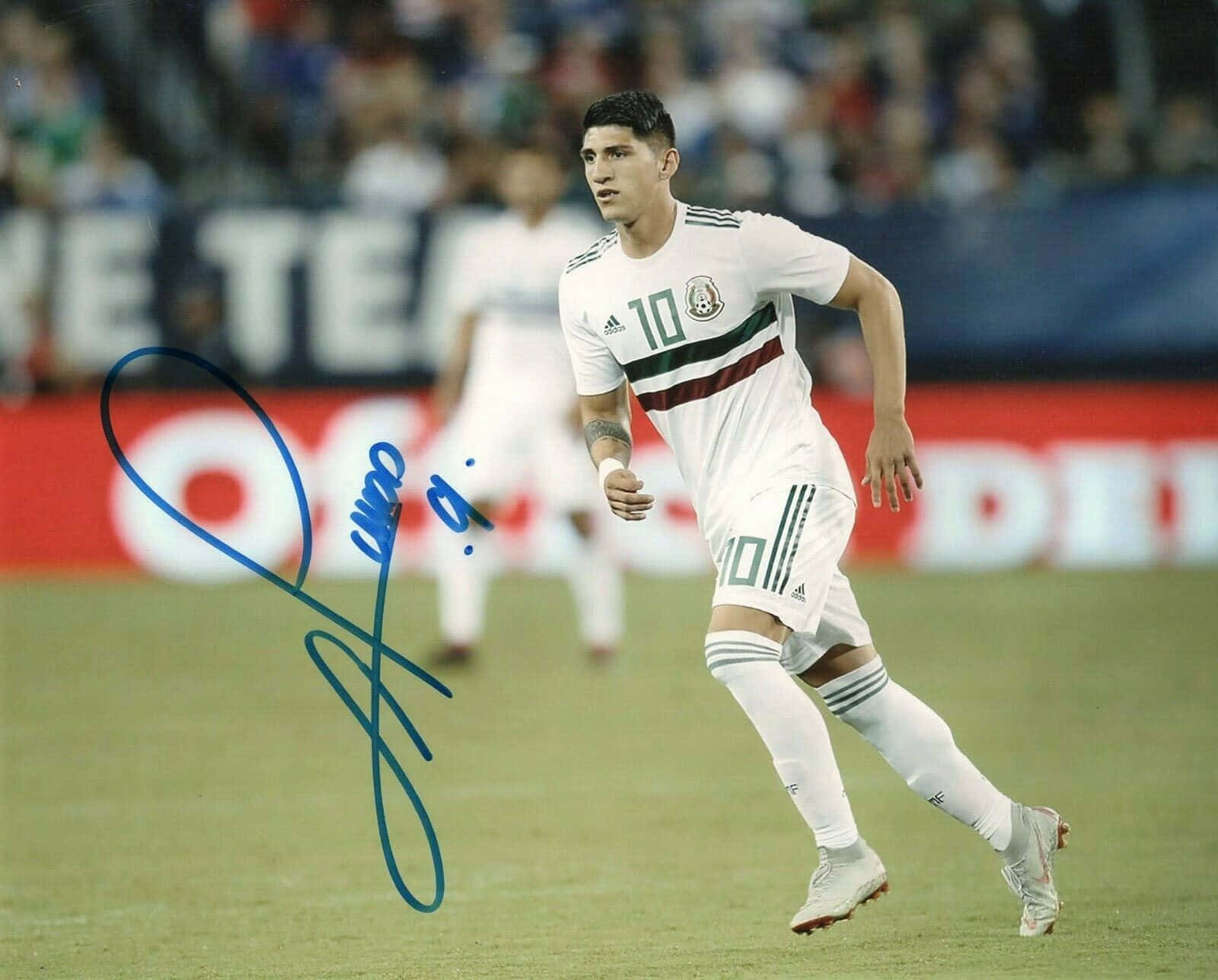 Professional Footballer Alan Pulido Making His Signature Move During A Match. Background