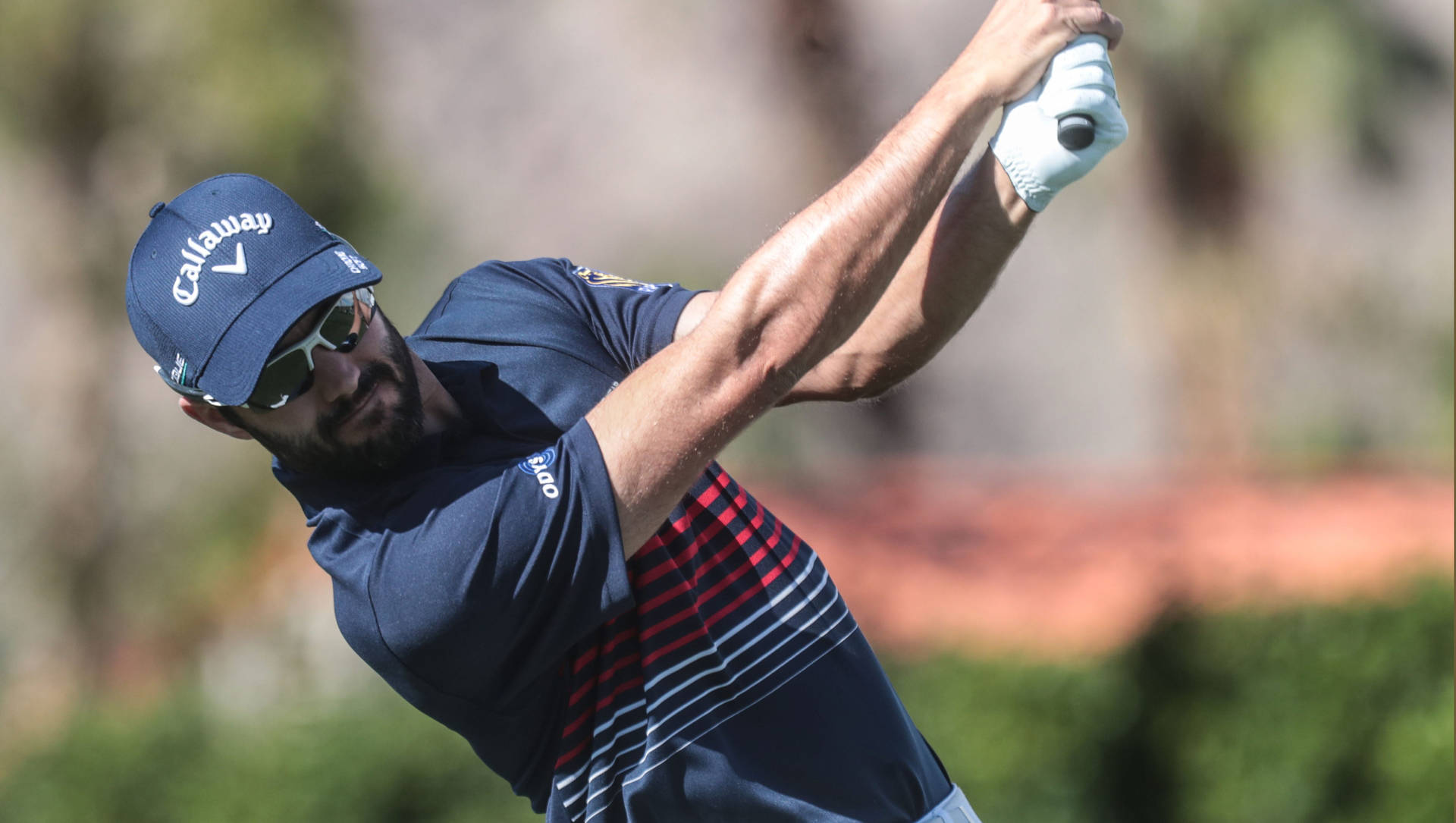 Professional Golfer Adam Hadwin In Action Background