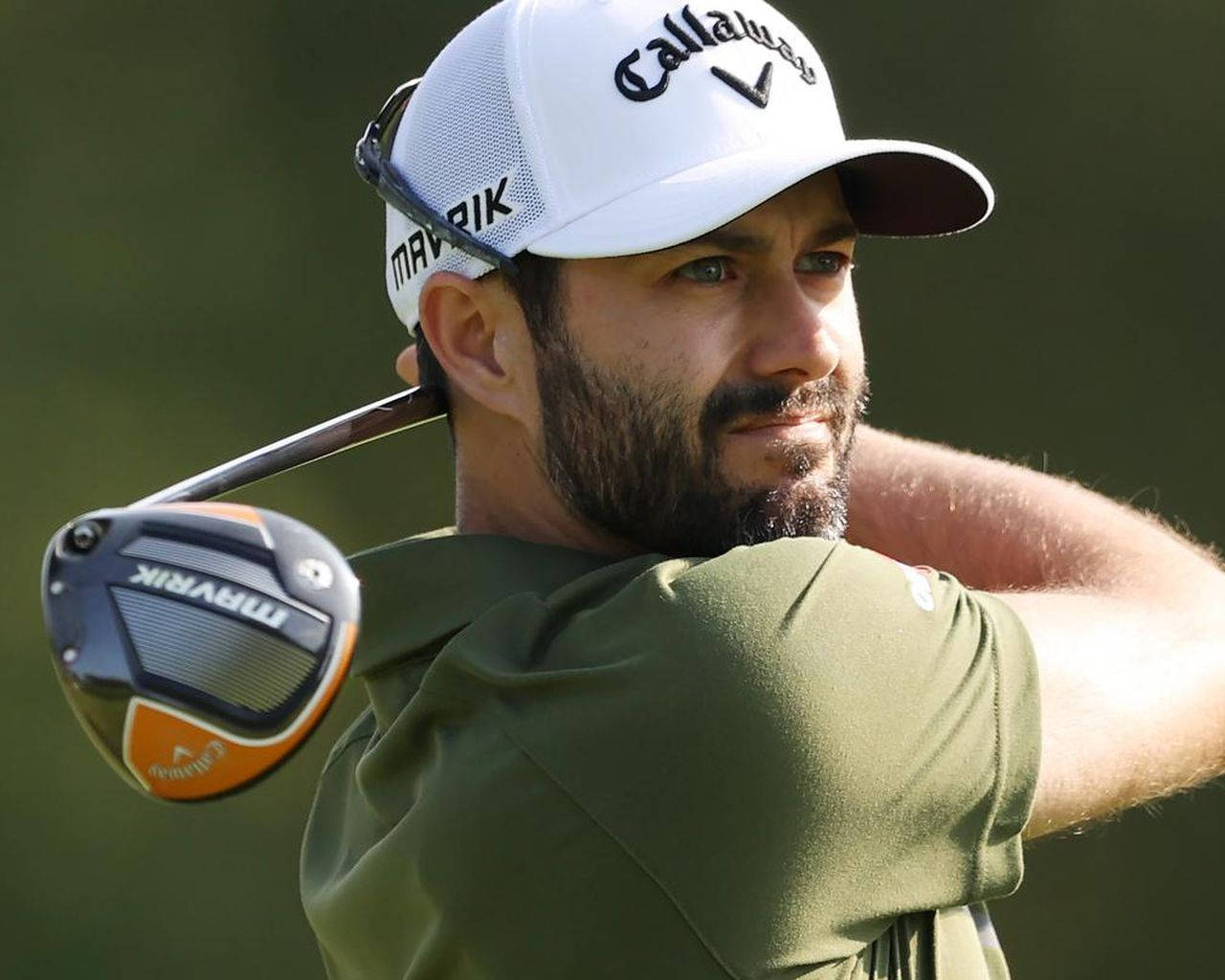 Professional Golfer Adam Hadwin Swinging On Course Background