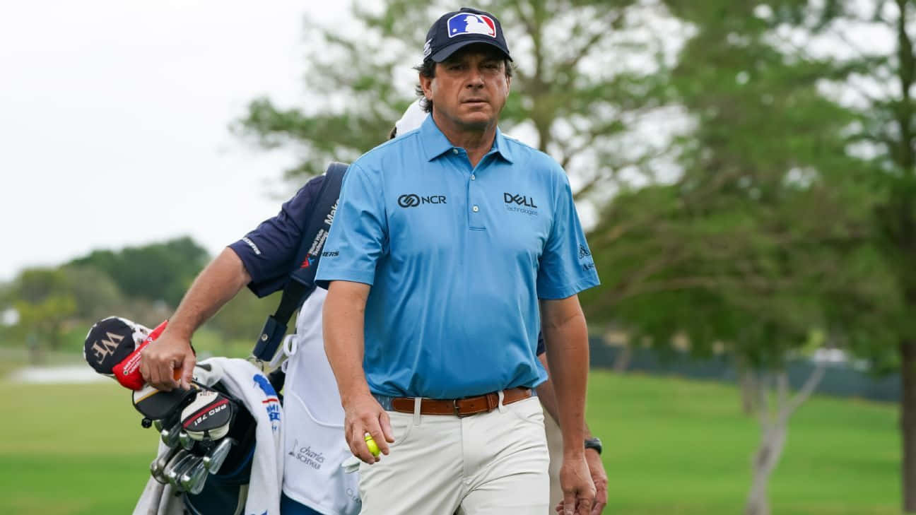 Professional Golfer Billy Andrade In Action With His Caddy Background
