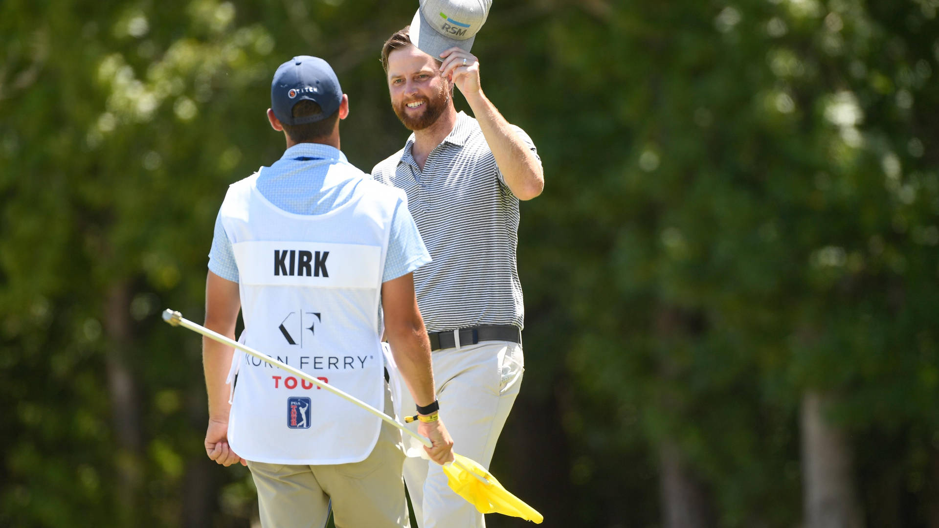 Professional Golfer Chris Kirk In Conversation With His Caddie During A Golf Tournament Background