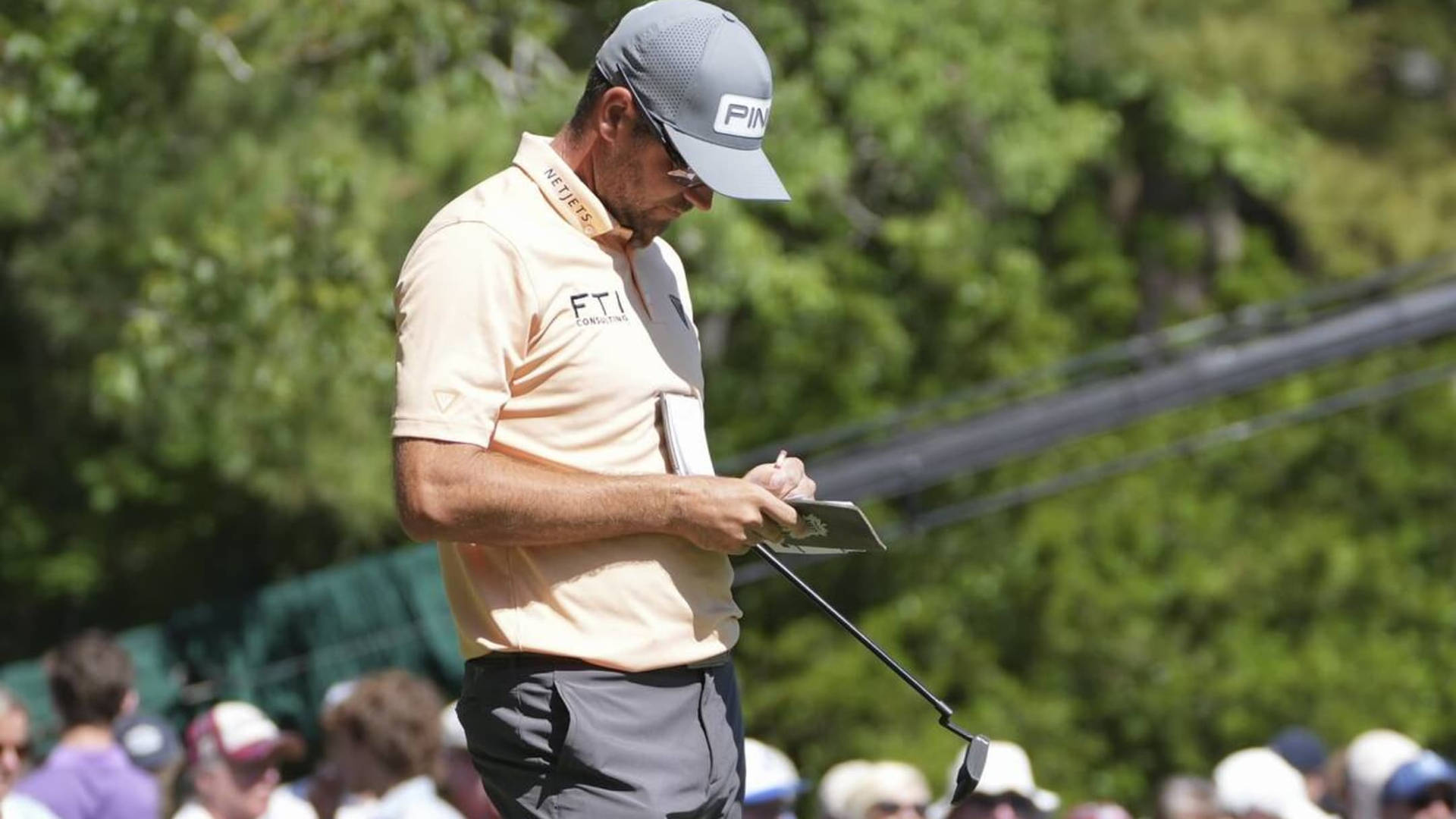 Professional Golfer Corey Conners Focused On Strategy Notes Background