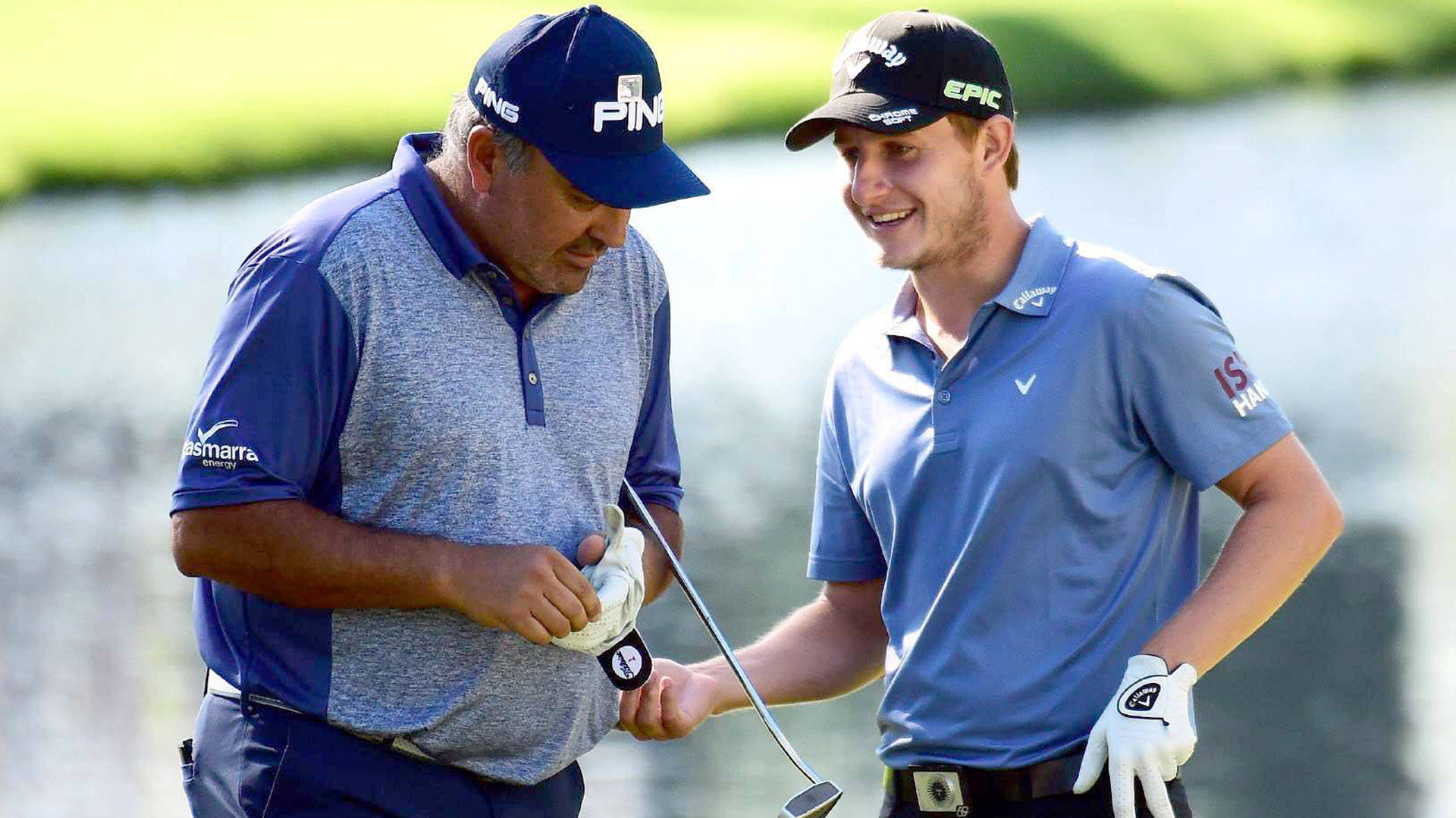 Professional Golfer Emiliano Grillo Skillfully Swings His Club On A Sunlit Course Background