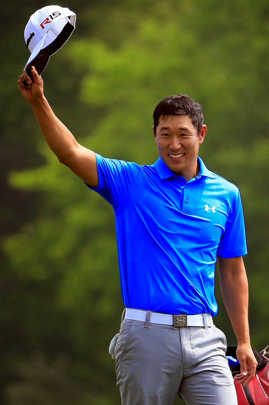 Professional Golfer James Hahn Smiling And Holding His Golf Cap. Background